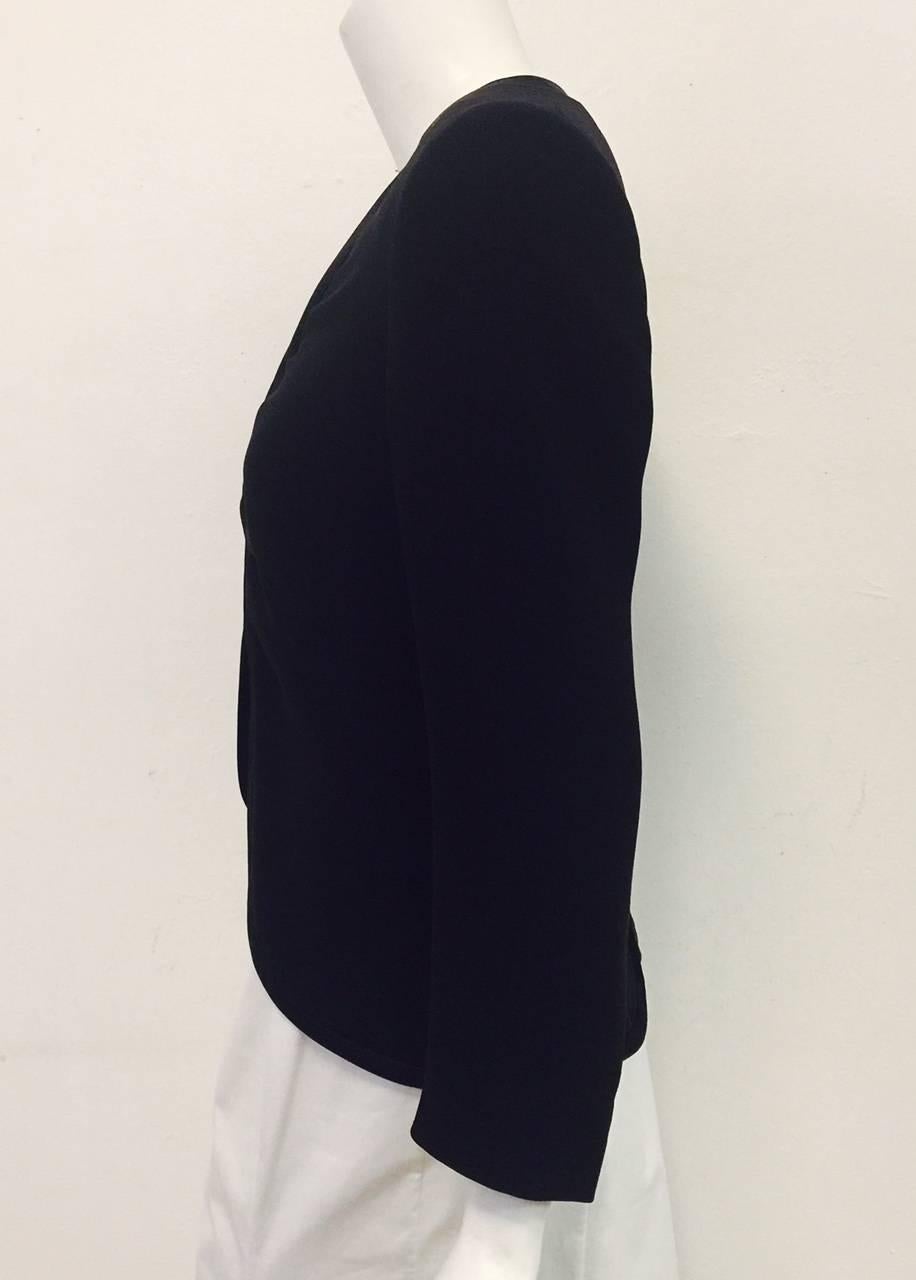 Giorgio's glamorous and practical Tuxedo style jacket is crafted from a luxurious wool/silk blend.  This jacket may be worn over a dress or with palazzo pants for an evening out.  This garment has a black silk trim around the neck, opening and back.