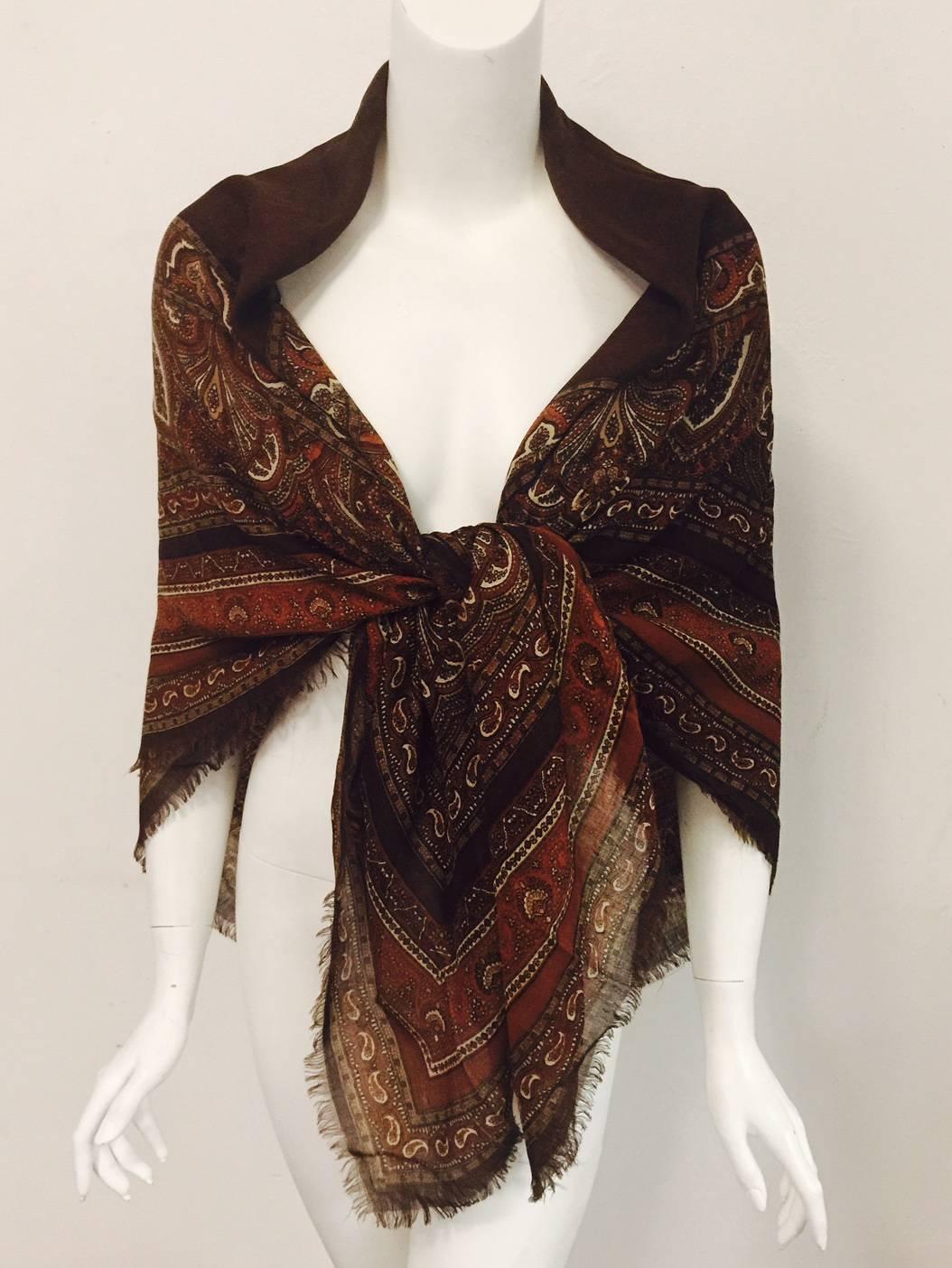 Featuring ultra-luxurious Wool and Silk Etamine blend, this vintage YSL Wool and Silk Etamine Paisley Shawl is a must for any sophisticated wardrobe.  Ageless, classic styling and warm colors, including chocolate, burnt orange, and parchment,