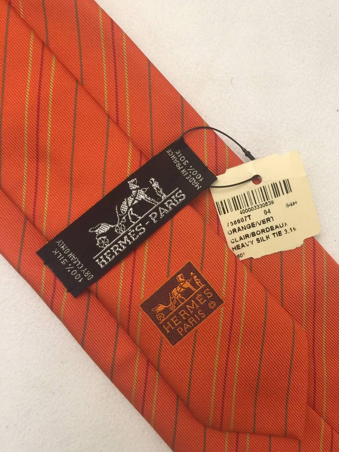 Cut a dashing figure in this classic tie by Hermes in classic Hermes verte orange cravat with a length of 58 inches, and width of  3.5 inches. Vintage 1980's. New with original hang tag.