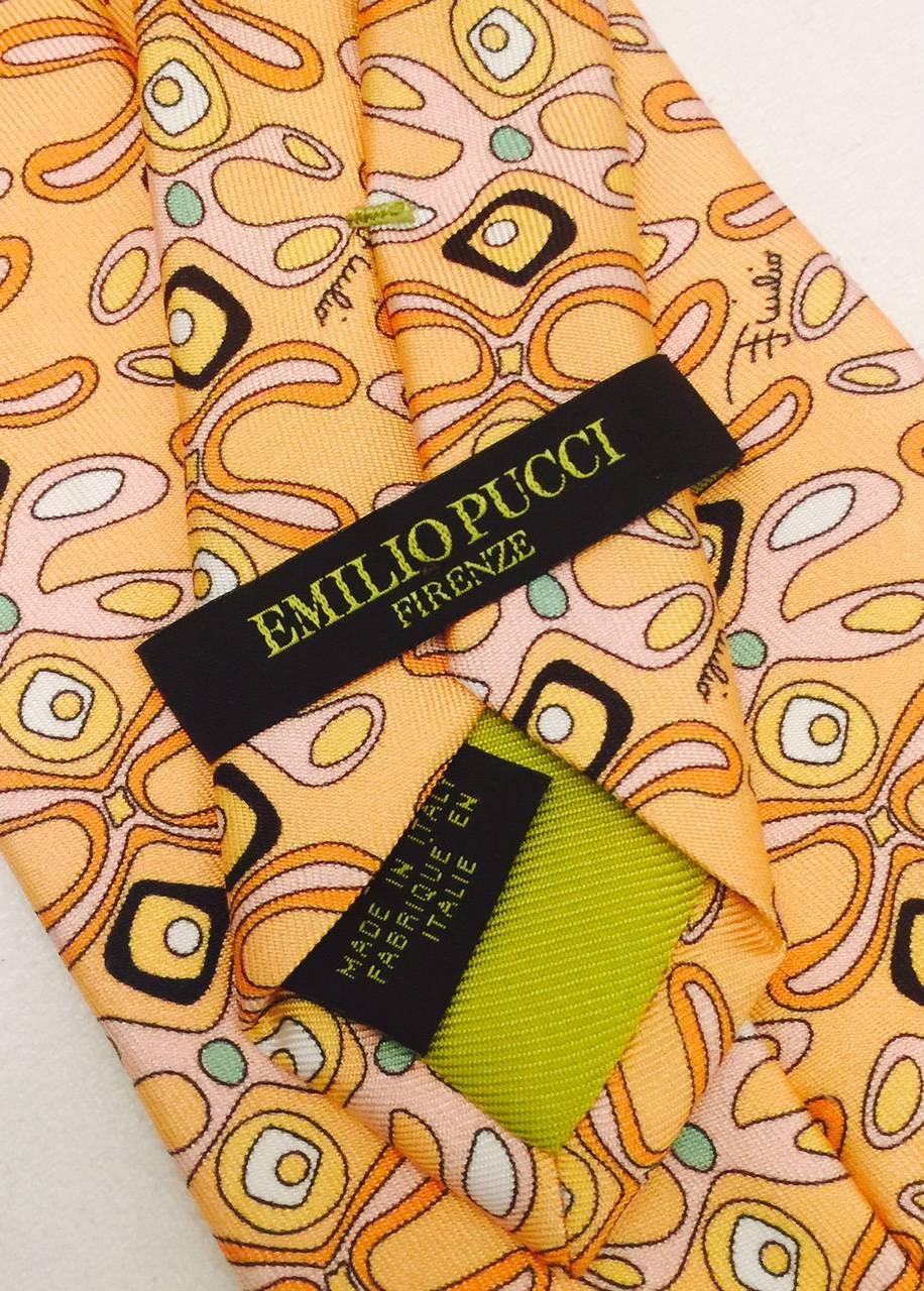 Iconic Emilio Pucci's iconic play on pattern in this tie from the 2000's.  Peach shades with touches of green and black pop in this silk classic.   Length is 60 inches, width is 3.5 inches.