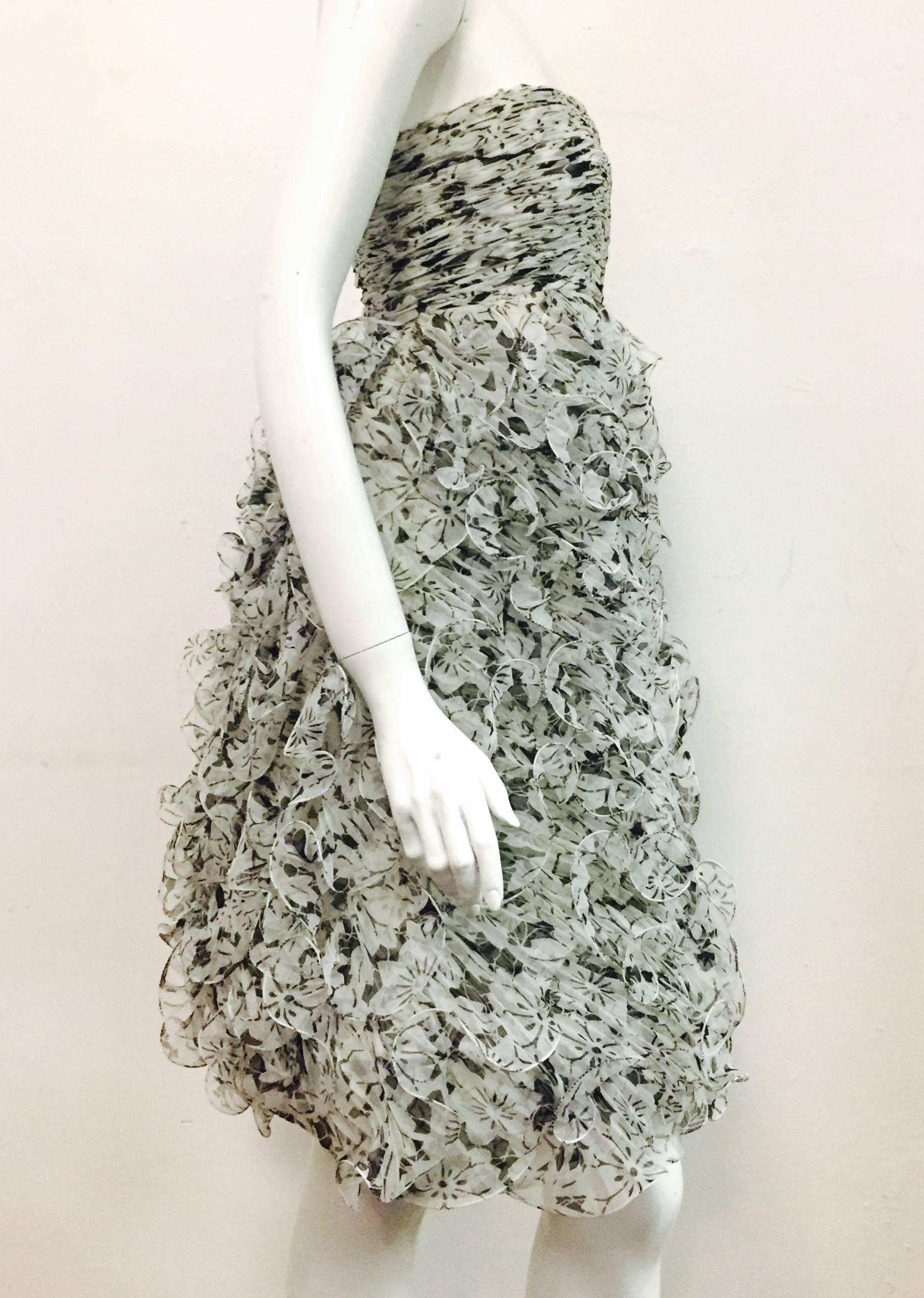 Breathtaking Oscar de la Renta Dress is meticulously constructed of black and white Silk Faille.  The bodice has a boned inner structure which includes a bra.  This bodice is created with the accordion pleats but in a ruched style empire waist.  The