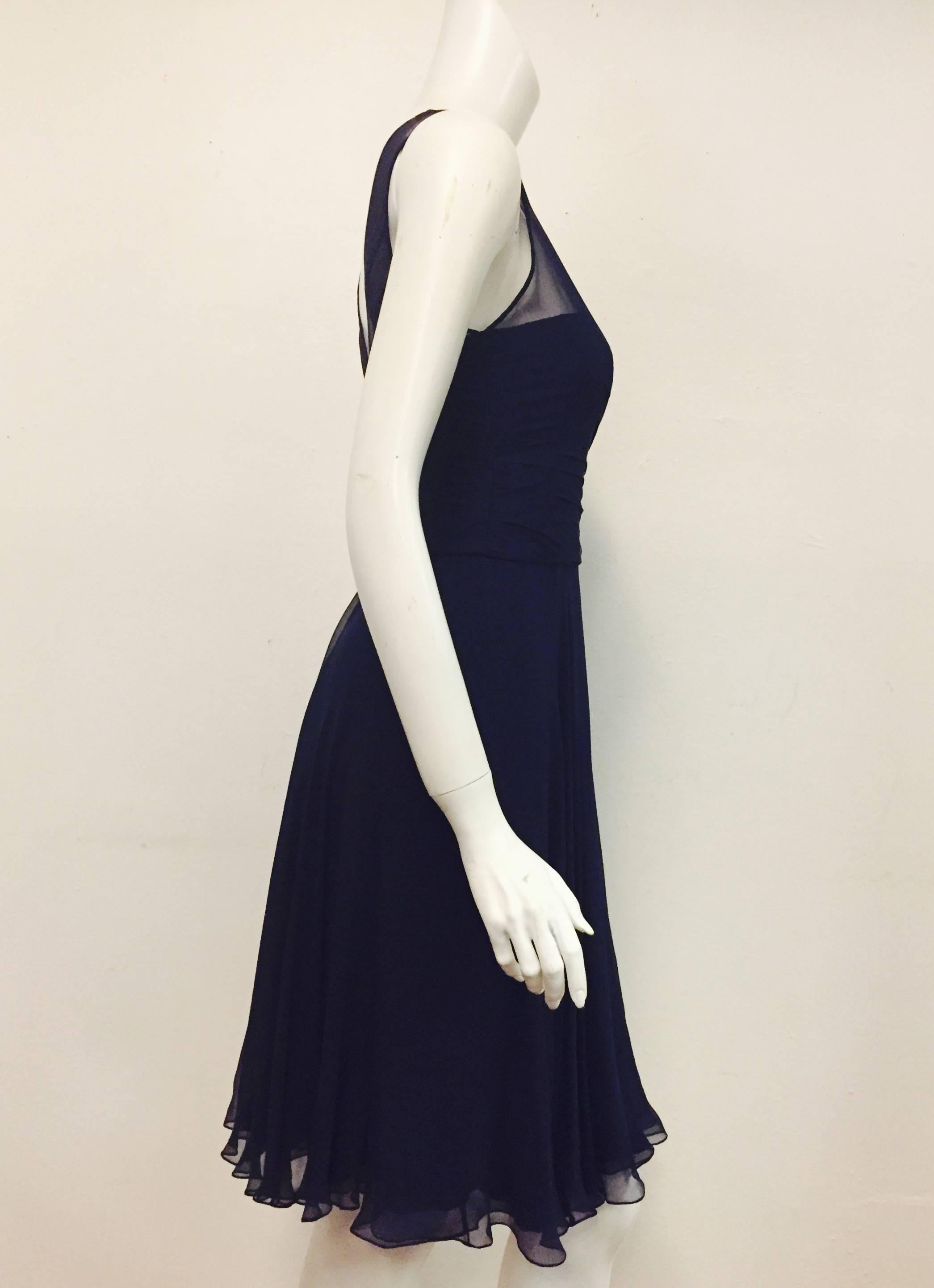 Ralph Lauren (Purple Label)  navy evening cocktail dress with hidden strapless top covered with the same see through silk material.  It is gathered at waist at front and also gathered at back to the waist.  For closure this delicate dress has a