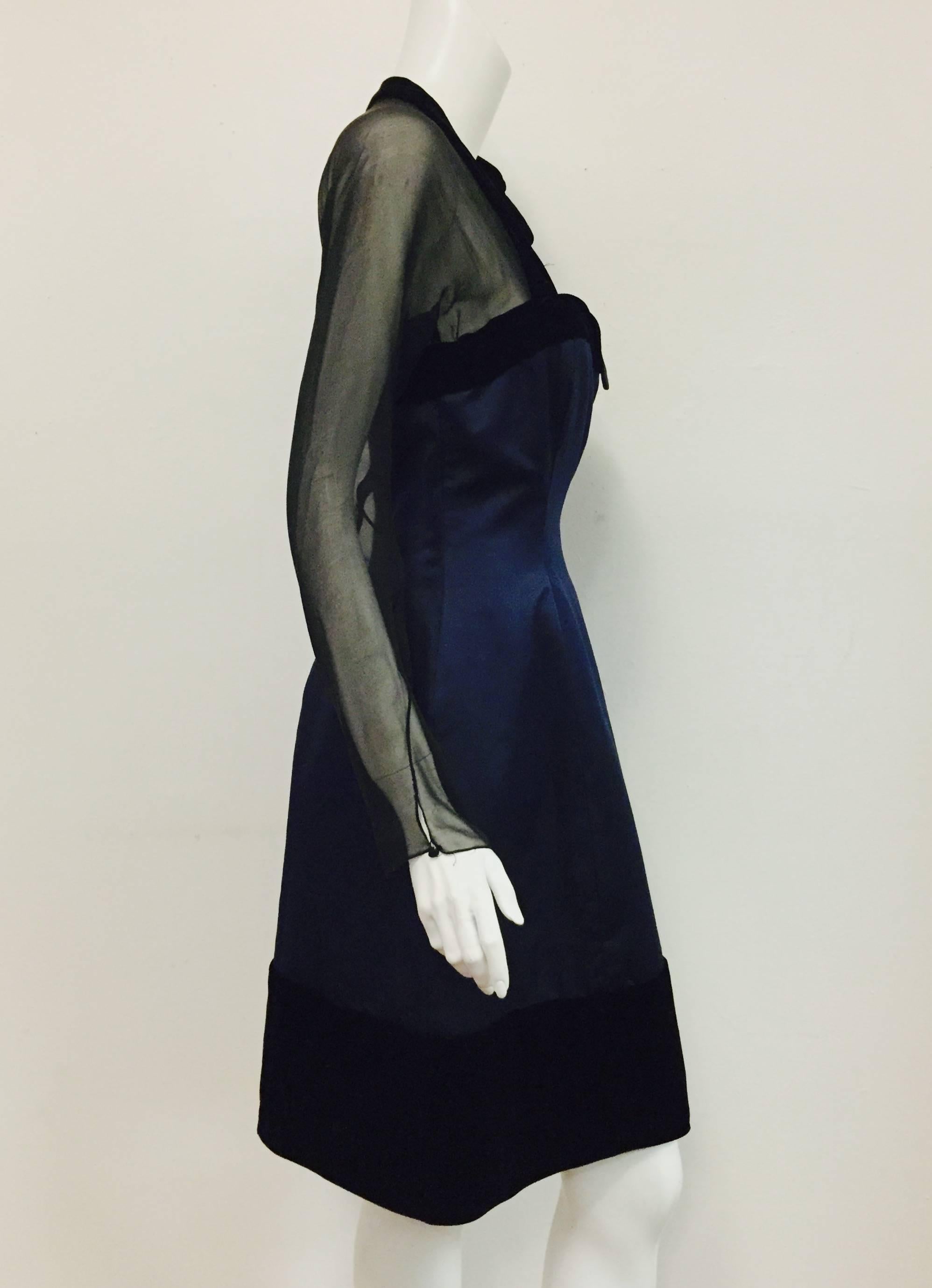 Oscar de la Renta's 1992 duchesse satin cocktail dress with black velvet trim at neckline and hem is elegance defined!  Black velvet bow on one side and sheer black chiffon illusion sleeves and upper back finish this couture dress.  

A boned bodice