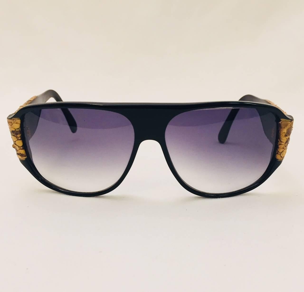 Vintage YSL Black Sunglasses prove that Yves Saint Laurent was not only an haute couturier but a legendary trend-setter as well!  Classic oversize aviator styling is perfectly complemented with ultra-luxurious brown and beige python accents on frame