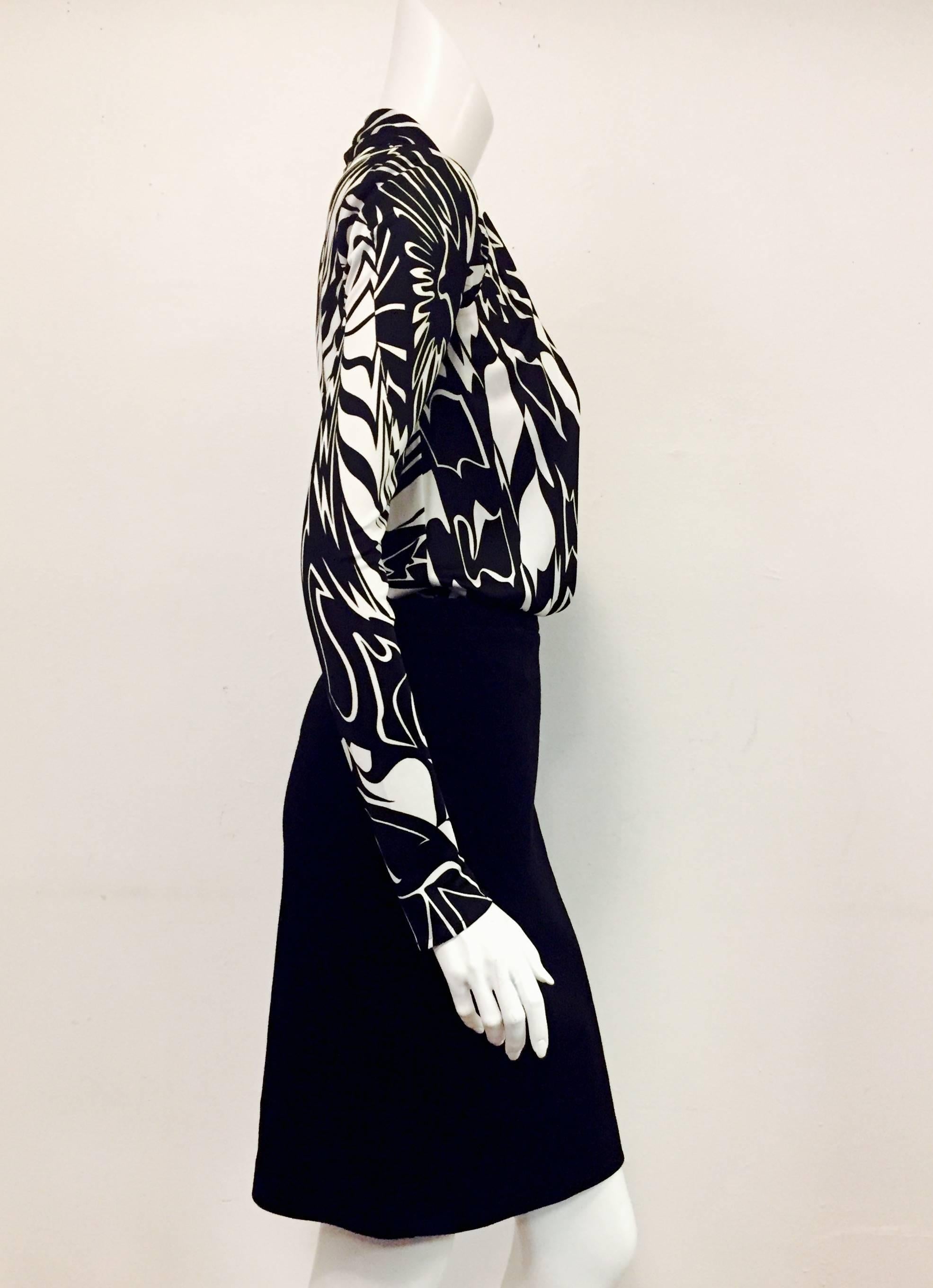 Extravagant Emilio's original design for this black and white long sleeve color block dress is creative and captivating!  The top has intricate abstract pattern and is construction with a faux vest and long sleeves.  This dress features a loose