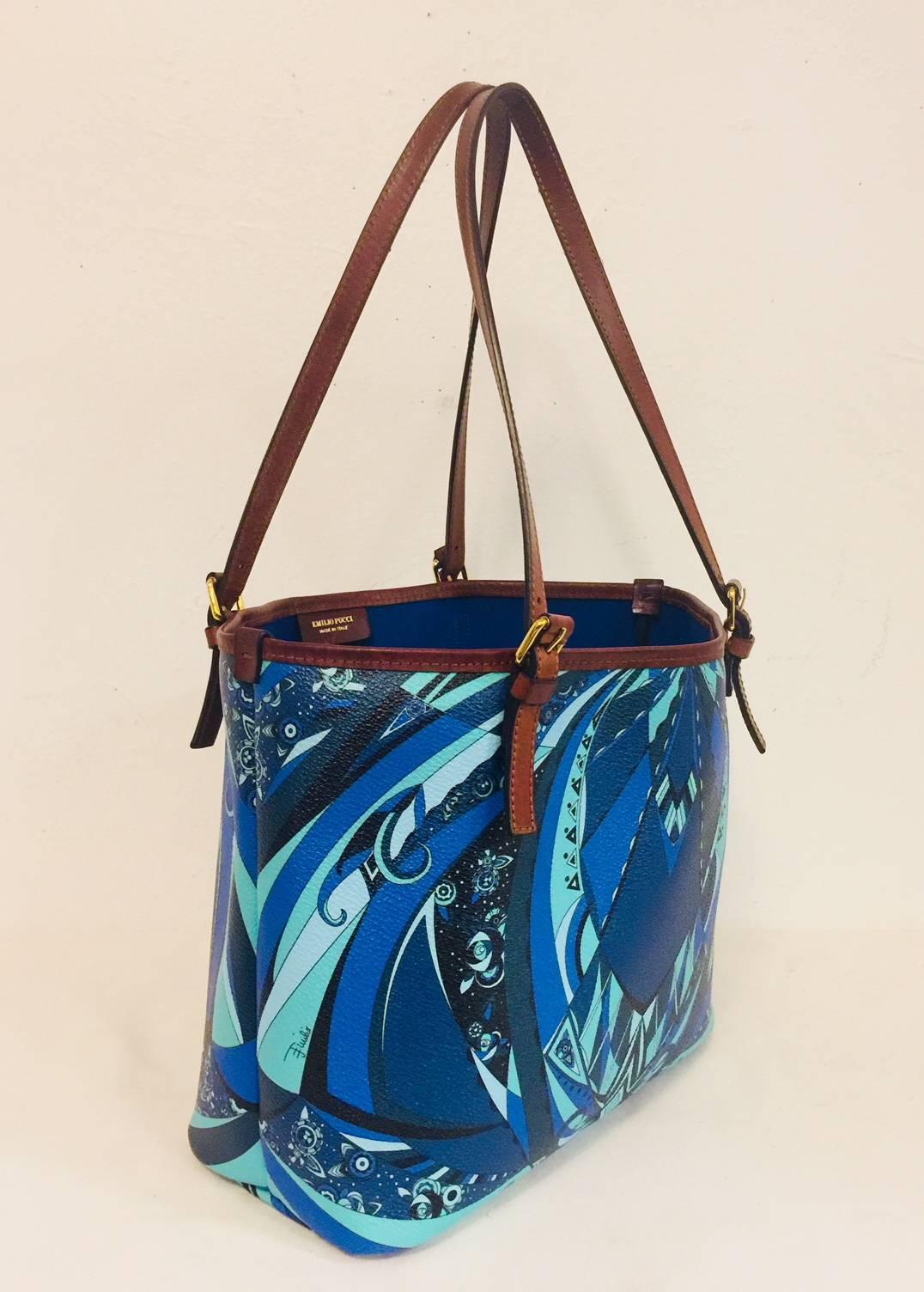 Renowned for eclectic, colorful, exuberant prints, Emilio Pucci designs have become required for all women of style!  This Rio Piazzo Tote features coated canvas body with signature, abstract blue and green print, dual, adjustable straps in cognac. 