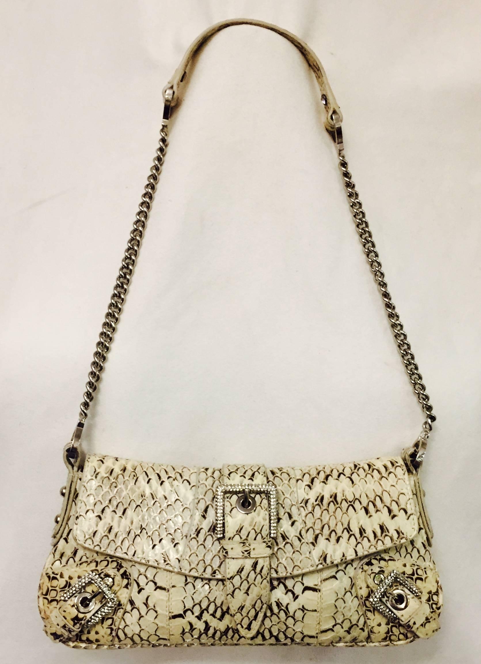 Deluxe Dolce & Gabbana Python Shoulder Bag easily transitions from day to evening!  Features ulra-luxurious snakeskin, expandable body, flap front and silver tone hardware including chain strap.  Dazzling crystal buckles on both corners and a larger