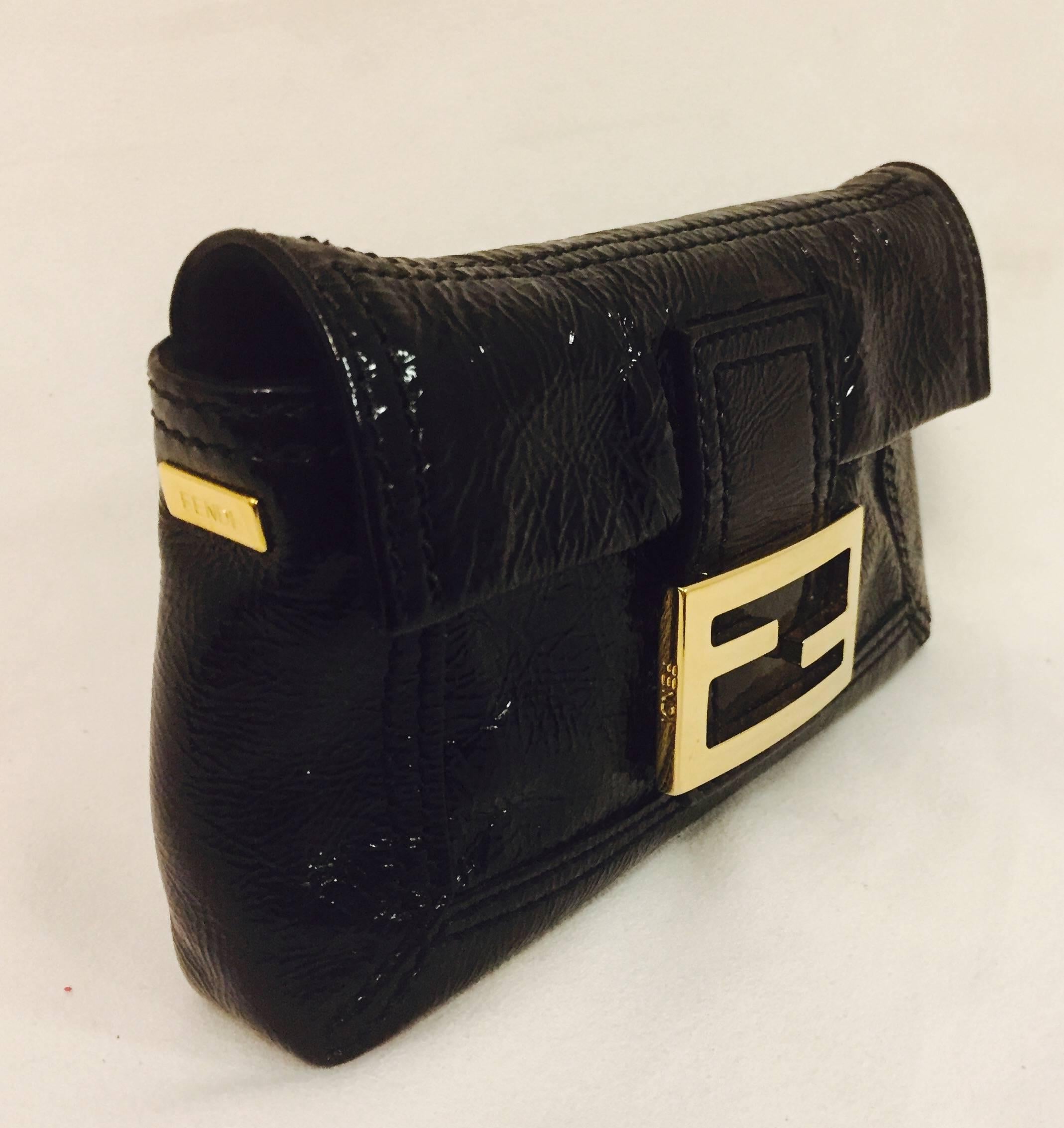 Fendi's black textured patent leather bag remains a great everyday bag that easily transitions from day to evening!  Its practical size holds one's smart phone, credit cards and make up!  The flap opening with gold tone, bold Fendi logo and magnetic