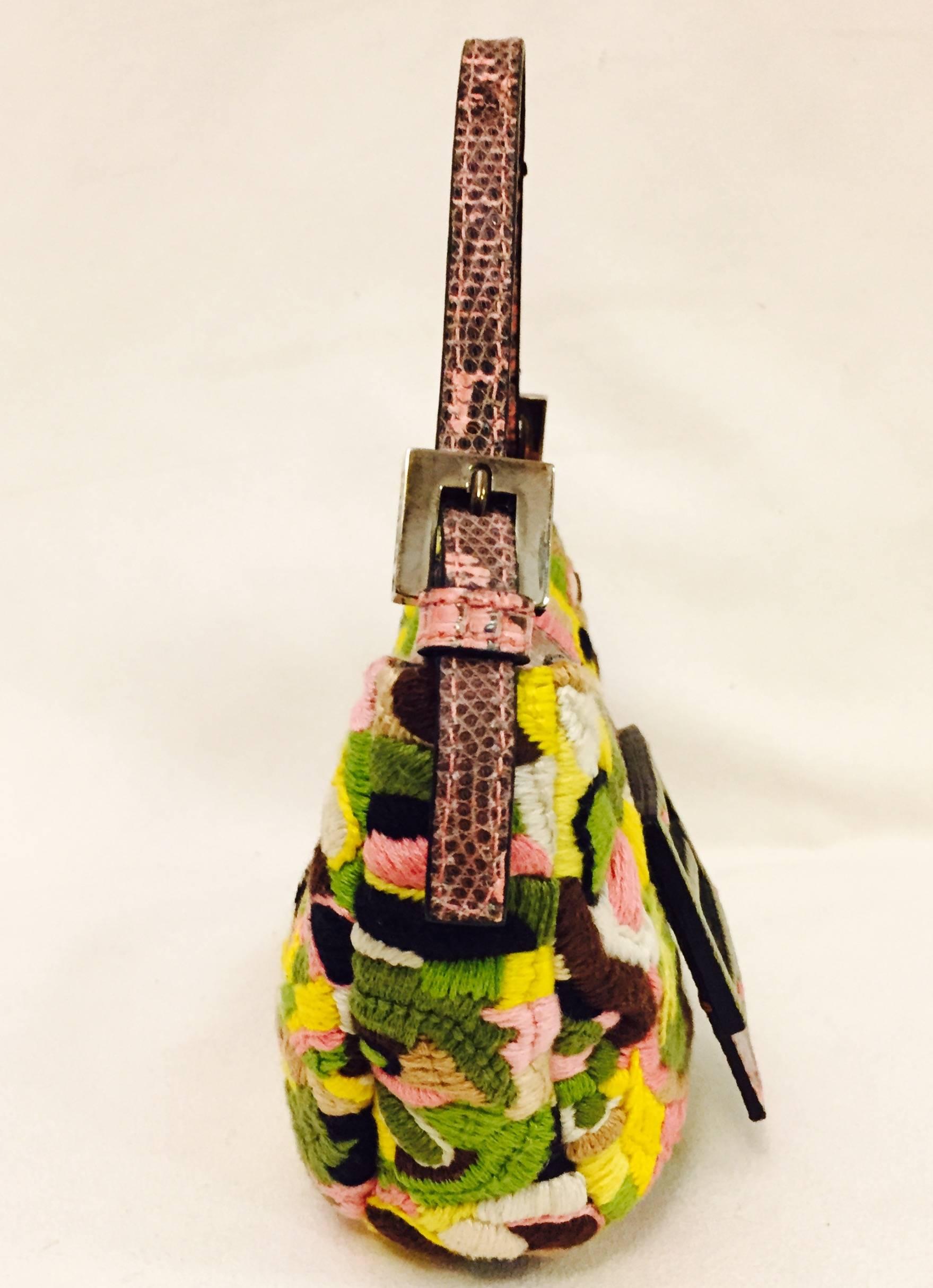 Fendi's multi colored floral embroided fabric mini bag is literally fabulous!  Unique pink lizard flap, green lizard Fendi logo and pink lizard strap differentiate this bag from the pack.  Interior is lined in yellow satin and sports a Fendi plaque