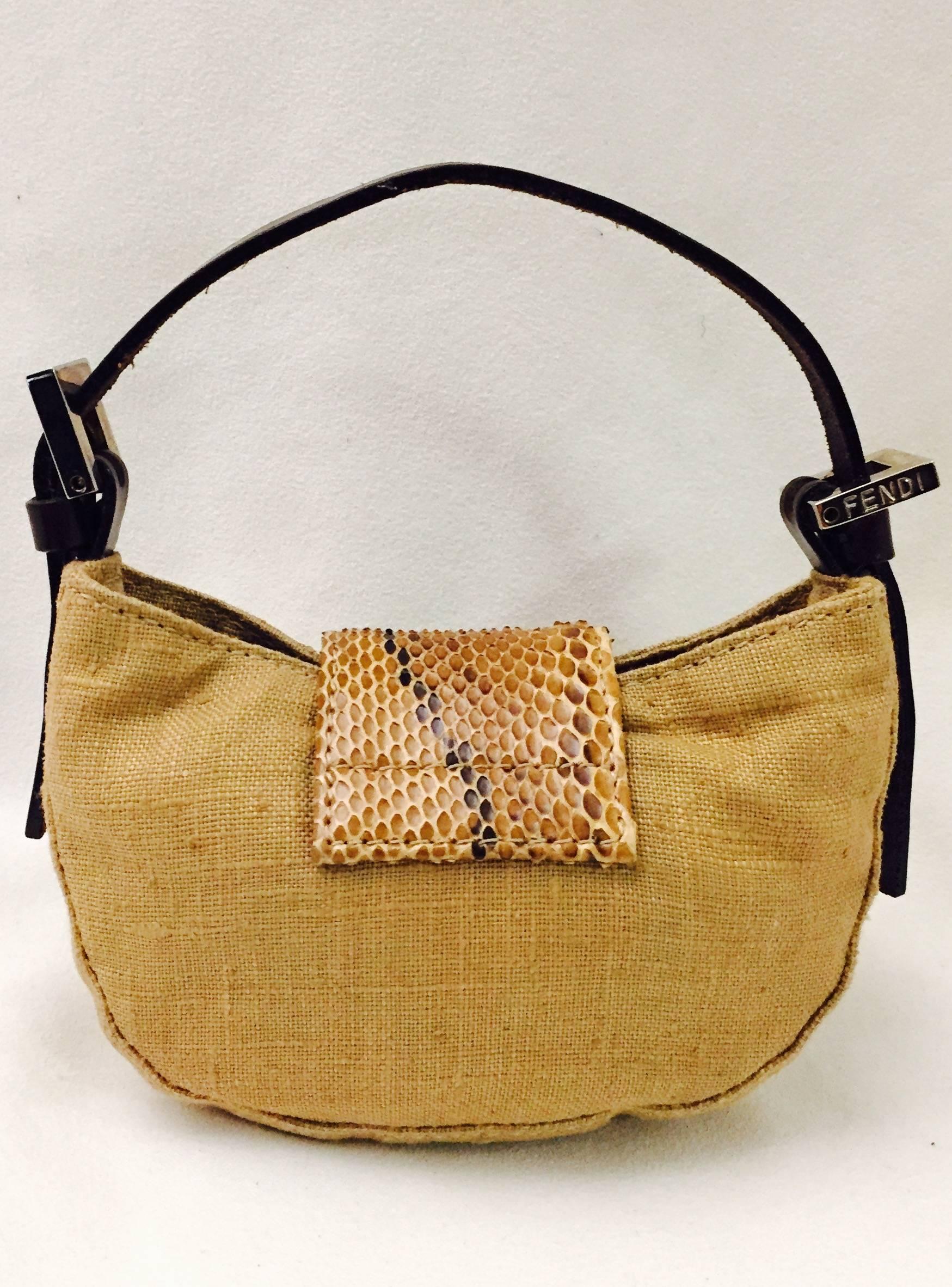 Fendi Mini Croissant bag is aptly named for its unmistakable shape.  Crafted from camel linen, bag features brown leather strap and luxurious beige python leather flap.  Iconic Fendi logo is highlighted with glorious green stone.  Hidden magnetic