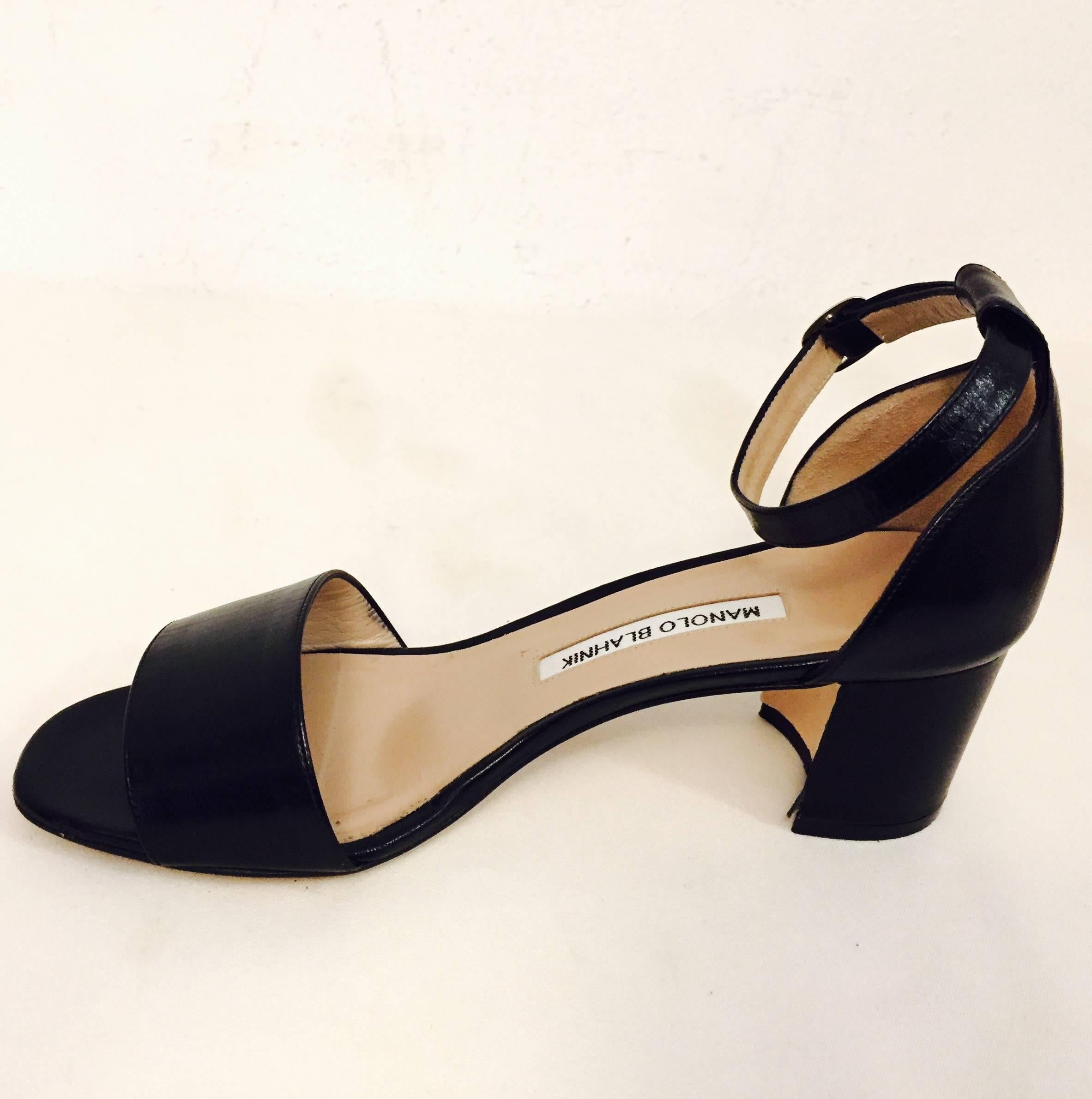 Manolo Blahnik's Lauratomod Black Leather Sandals features single strap design and sculpted block heels.   Ankle straps assure proper support and comfortable wear.   Tan Leather soles, insoles, and lining.   Silver tone buckles complete the look. 