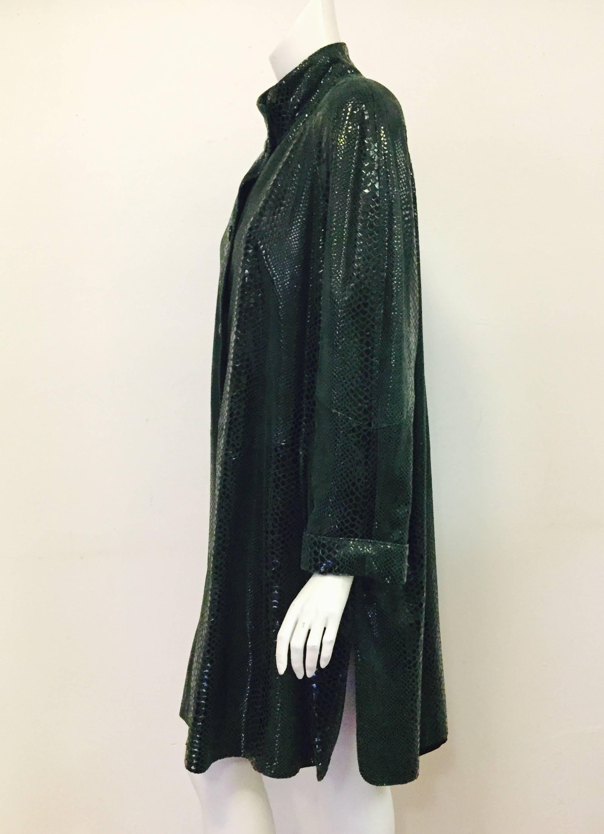 Philippe Vallereuil for years has created and manufactured leather clothing  ( jackets, coats, trousers, skirts, etc.), shearling and fur coats.  This unique green animal stamped leather coat is current and fashionable.  A swing style leather coat