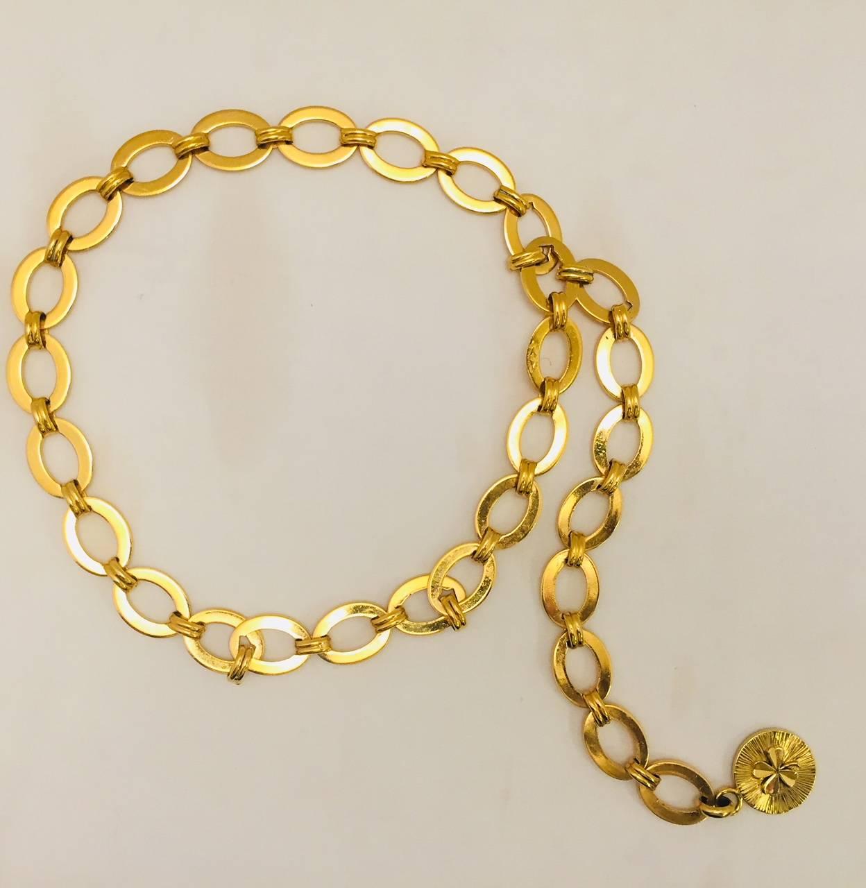 The legend of Coco Chanel lives on in closets of fashionable women world wide!  This classic belt is instantly recognizable!  Fabricated in goldtone, it has open oval links connected by oblong ribbed links.  A double sided round medallion features