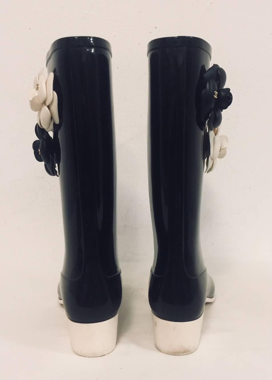 Chanel Black Wellington Boots prove that function can be fashionable...HIGHLY fashionable! A rainy forecast will be welcomed by anyone wearing these distinctly Chanel Wellington Boots. Features black glossy waterproof material and cap toe with