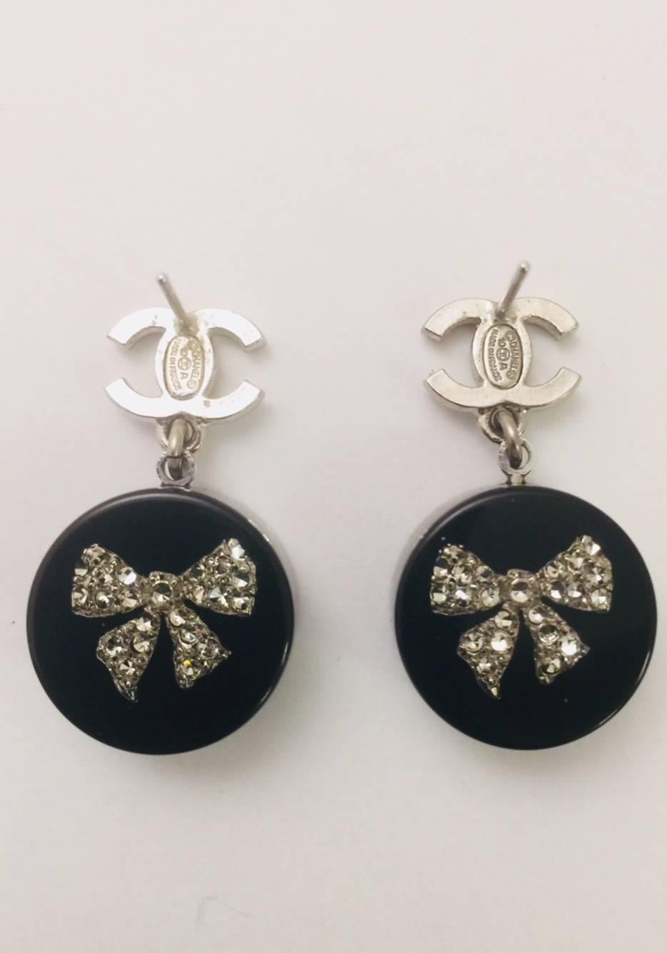 There isn't a fashionable woman in the world who doesn't recognize Chanel!  These impossible to find pierced earrings are a must have for Chanel collectors!  Fashioned with the ever iconic CC logo in crystals with a drop black resin circle