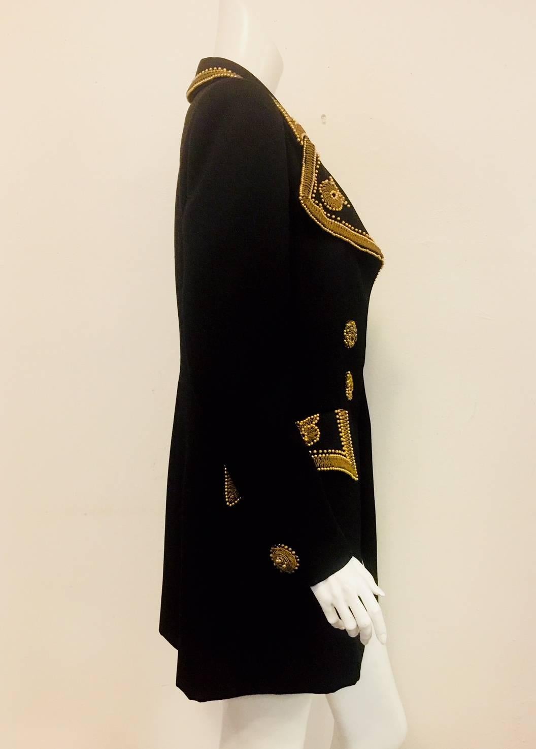 Louis Feraud intricately designed and crafted this vintage late 20th century black jacket with gold tone cord and faux golden pearls around the notched collar, front opening and the 2 flap faux pockets.  This long sleeve jacket is embellished with