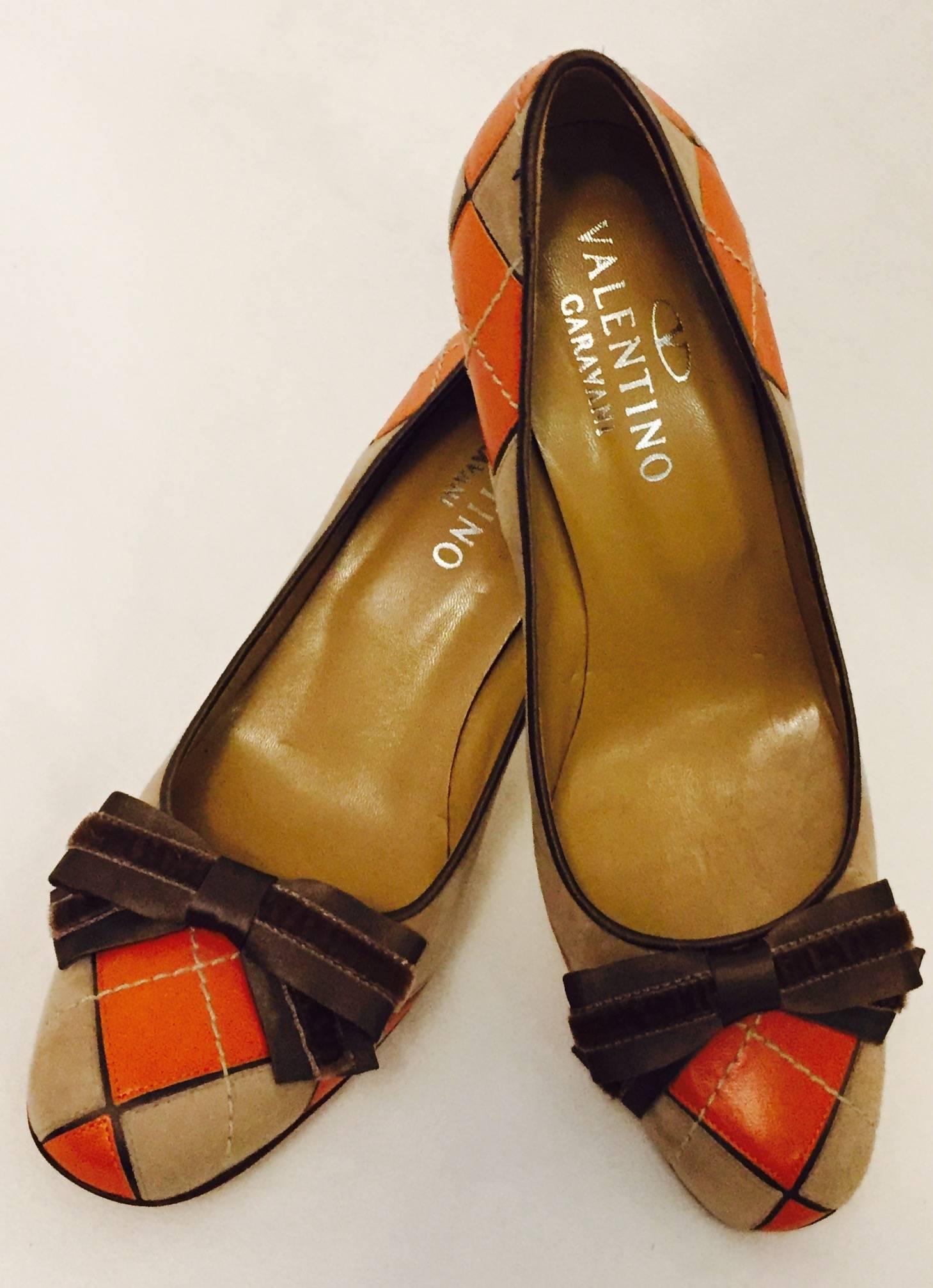 Valentino Garavani Round Toe Pumps prove that the argyle pattern is not just for socks and sweaters!  Features exquisite Orange Leather and Beige Suede uppers with topstitching that creates argyle pattern.  Leather soles, insoles and lining. 