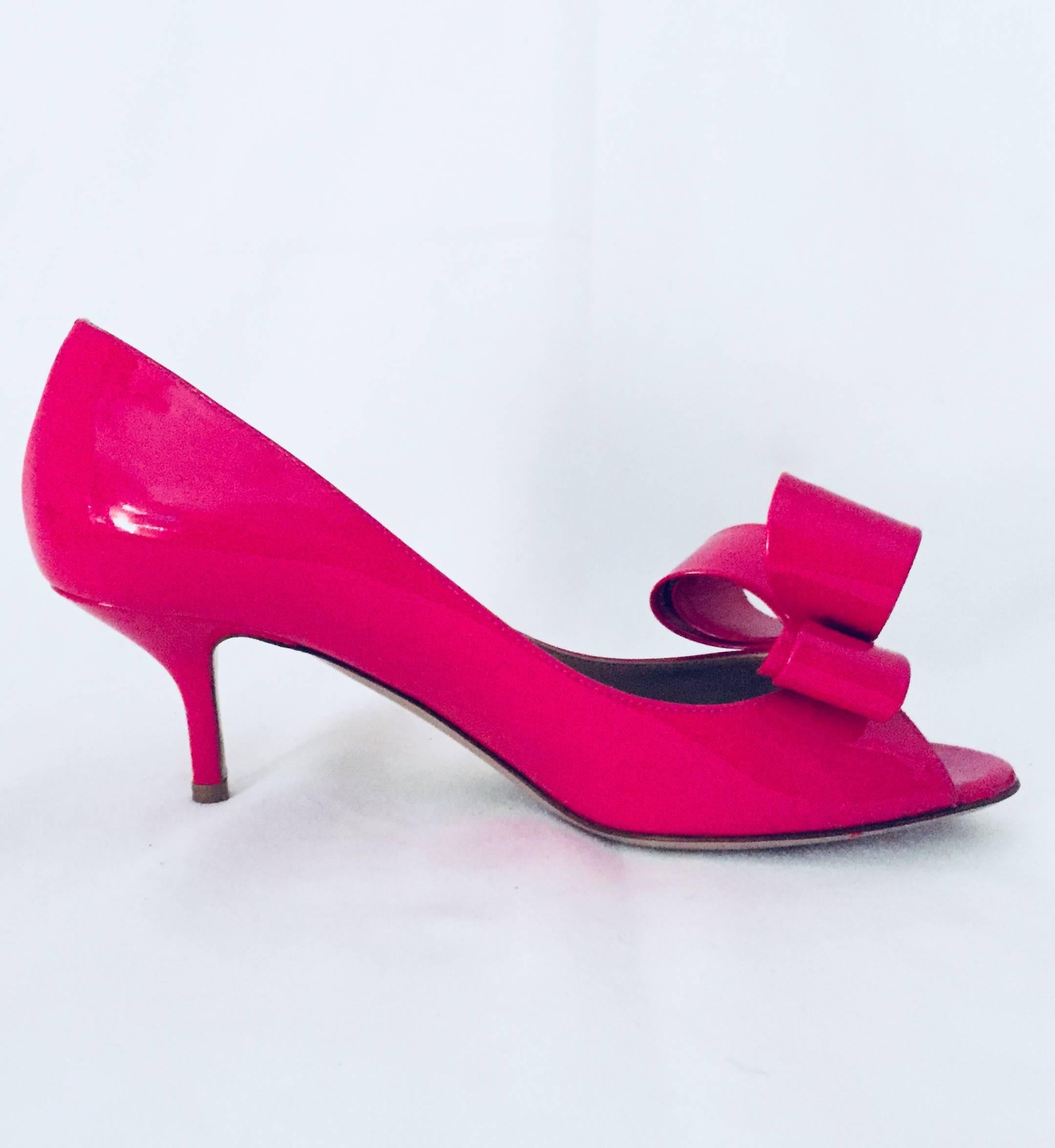 Fuchsia Patent Leather Peep Toe Low Pumps are quintessential Garavani!  Leather soles, insoles and lining.  Feminine to a fault, these pumps are finished with signature Valentino Bows.  Excellent Condition.  Limited Wear With Original Box.  Heel