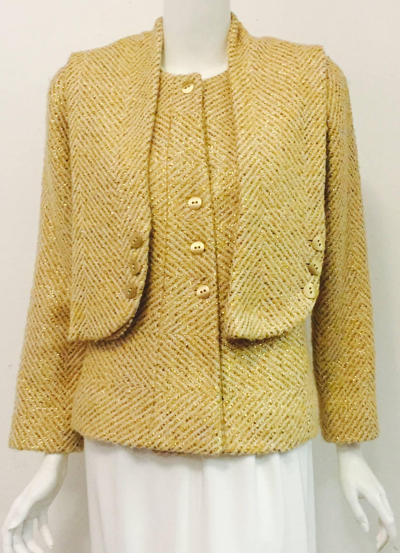 Chanel wool and silk blend cream color fabric with gold tone ribbons woven diagonally is elegantly designed.  This jacket makes a statement on its own and with the scarf it's sensational!  The jacket has a round neckline with 4 gold tone signature