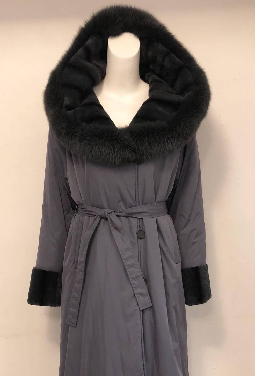 Alluring Argjrjou coat is expertly crafted in Canada using only the finest materials.  Features maxi length, raglan sleeves, durable, yet sophisticated, nylon exterior, two welt pockets and optional belt.  3-button closure secures the front. 