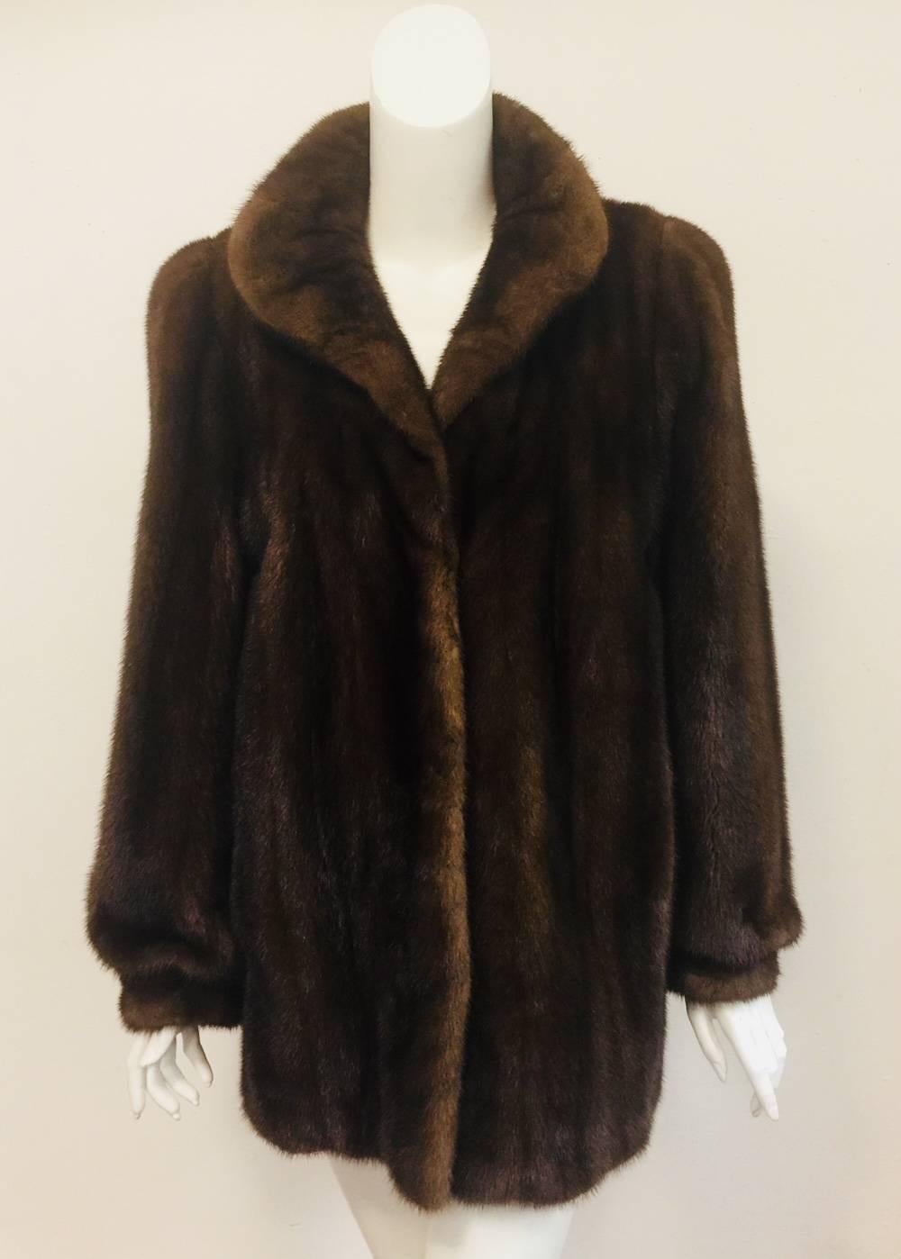 Saks Fifth Avenue's Fur Salon is legendary.  This luxurious brown mink jacket by Revillon features only the best pelts and exalted craftsmanship that dates back to the early 18th century!  Four hook and eye closures, two pockets and rounded collar. 