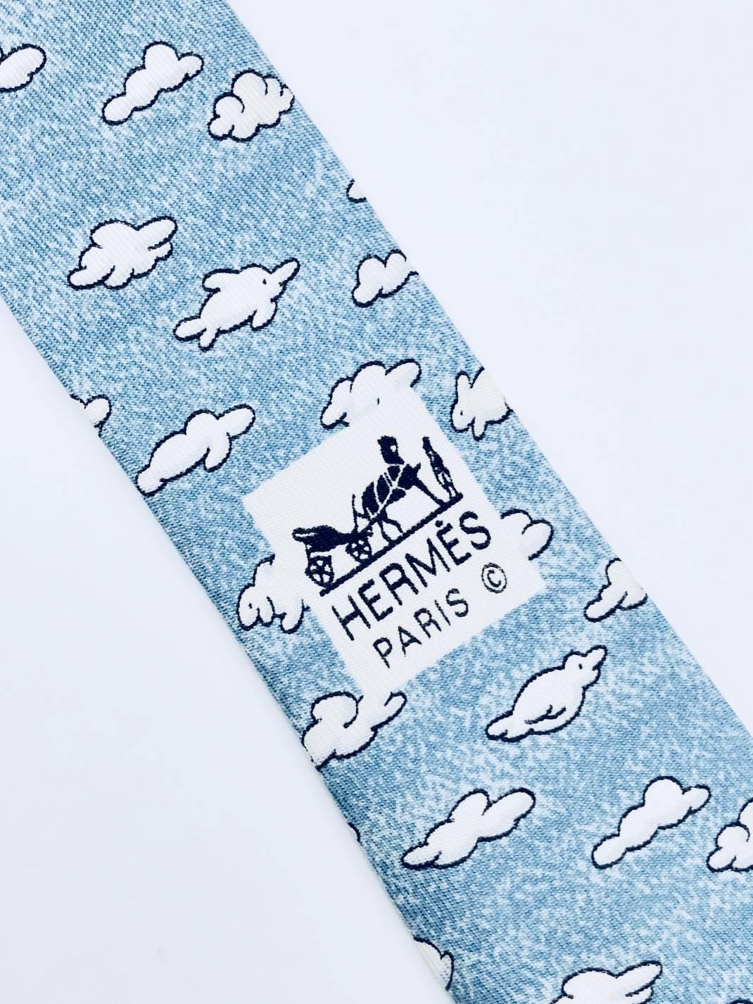 How delightful, heavenly Hermes silk tie with clouds floating across a blue  sky, look closely for the clouds shaped as dolphin, sheep and ducks, so dreamy!  Length 56 inches, width 3.75 inches.