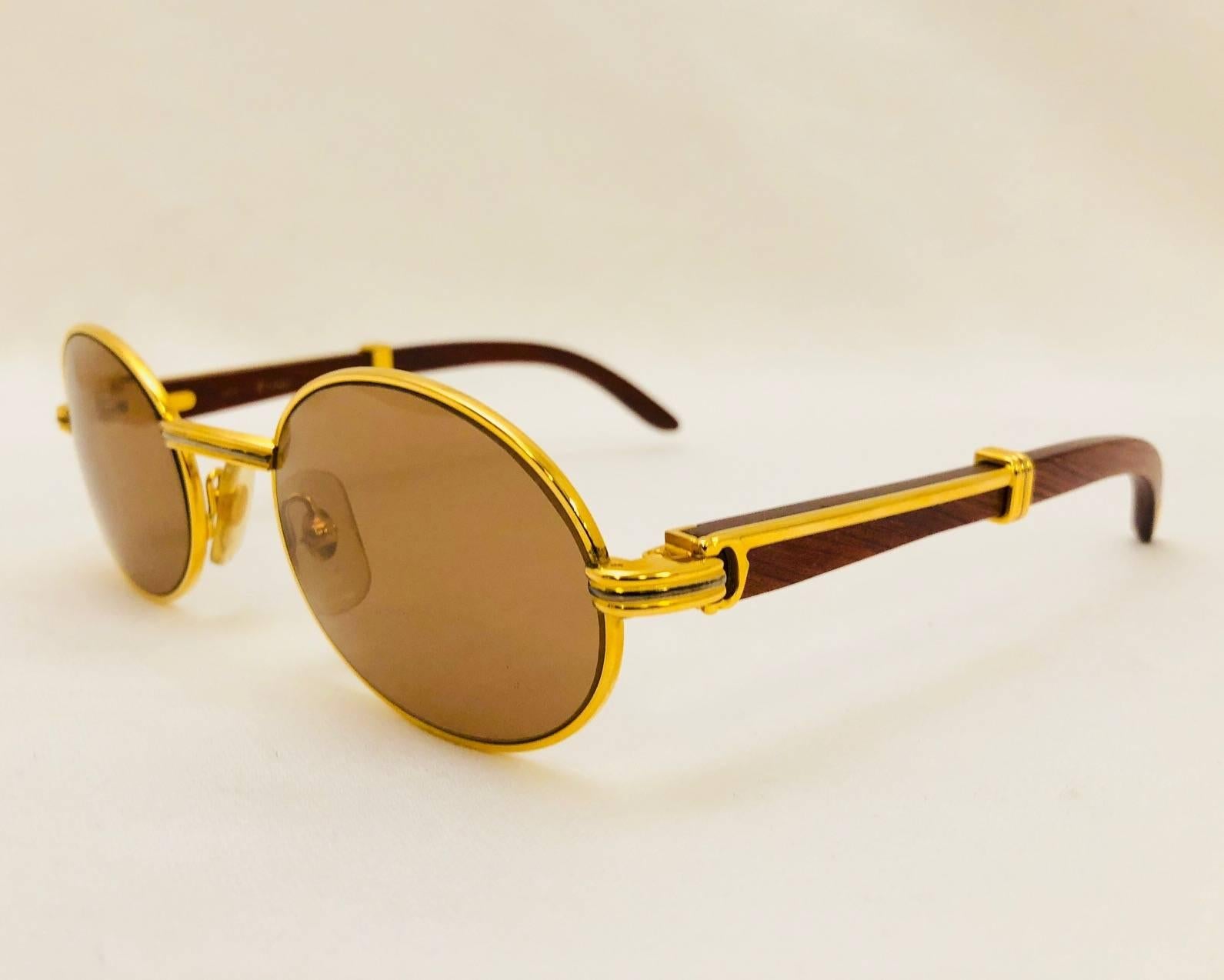 Cartier crafted the ultimate pair of sunglasses out of 18K Gold and Rosewood.  Known as 