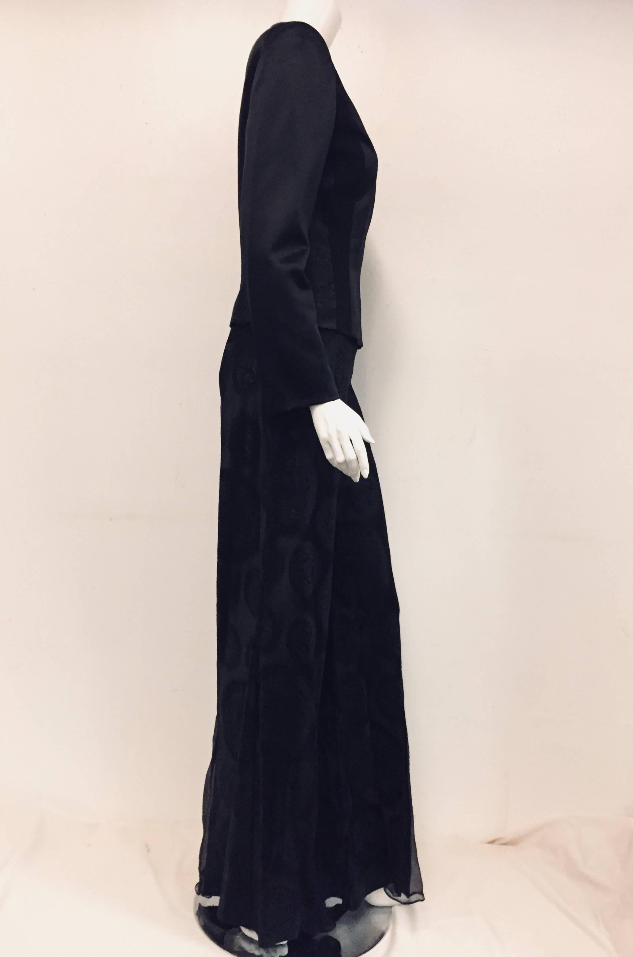 This John Galliano black wool and silk pant suit with oriental medallions allover the  palazzo pants is as inspiring today as when it was designed.   A round neckline, front zipper closure and different cut fabric strips fashioning a vertical