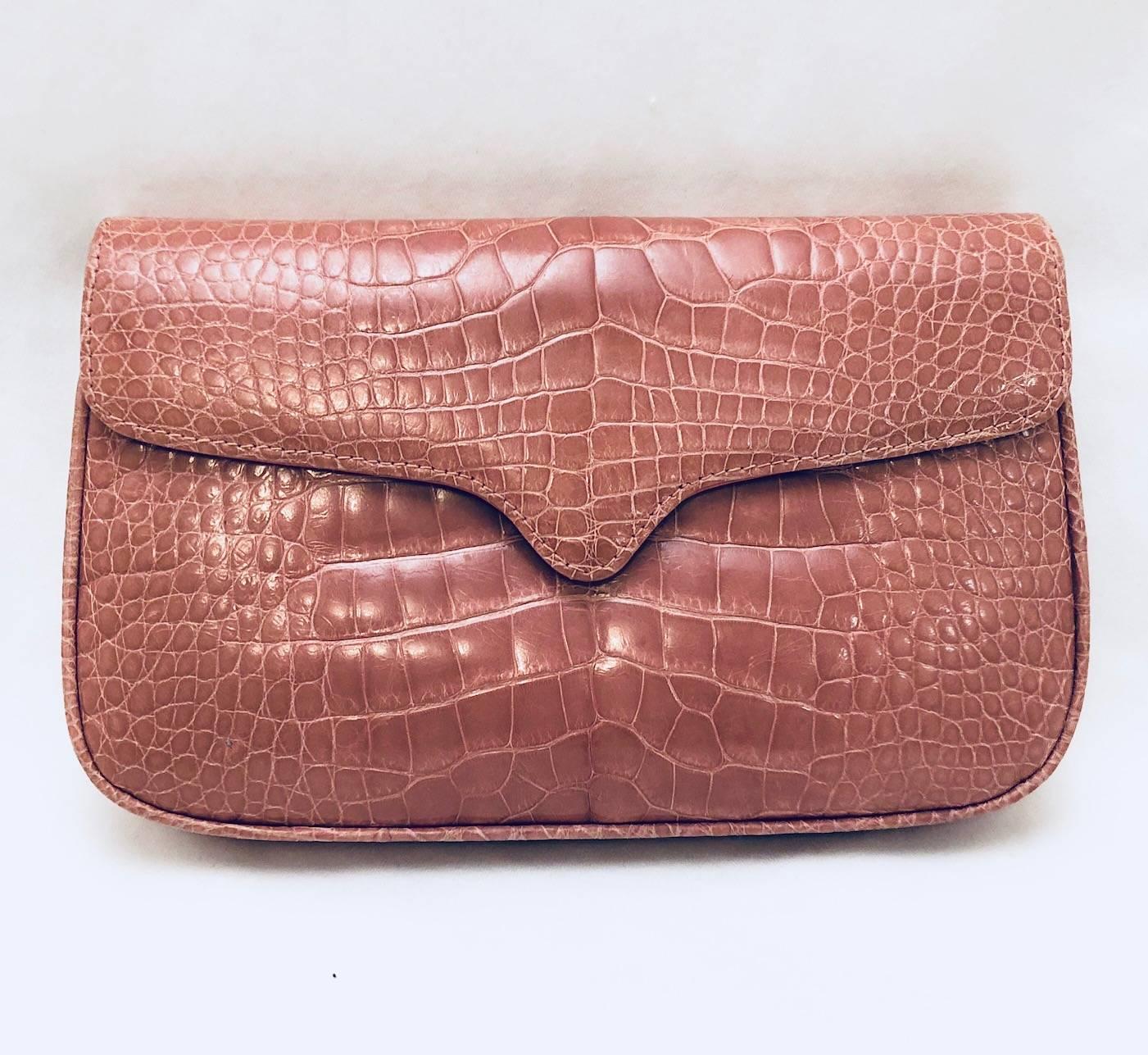 Luxurious, versatile, dusty mauve crocodile bag includes an optional blush pink beaded strap.  Of course, shoulder bag converts to a remarkable clutch!  Crafted from the finest materials, structured bag has flap front that opens to reveal pink