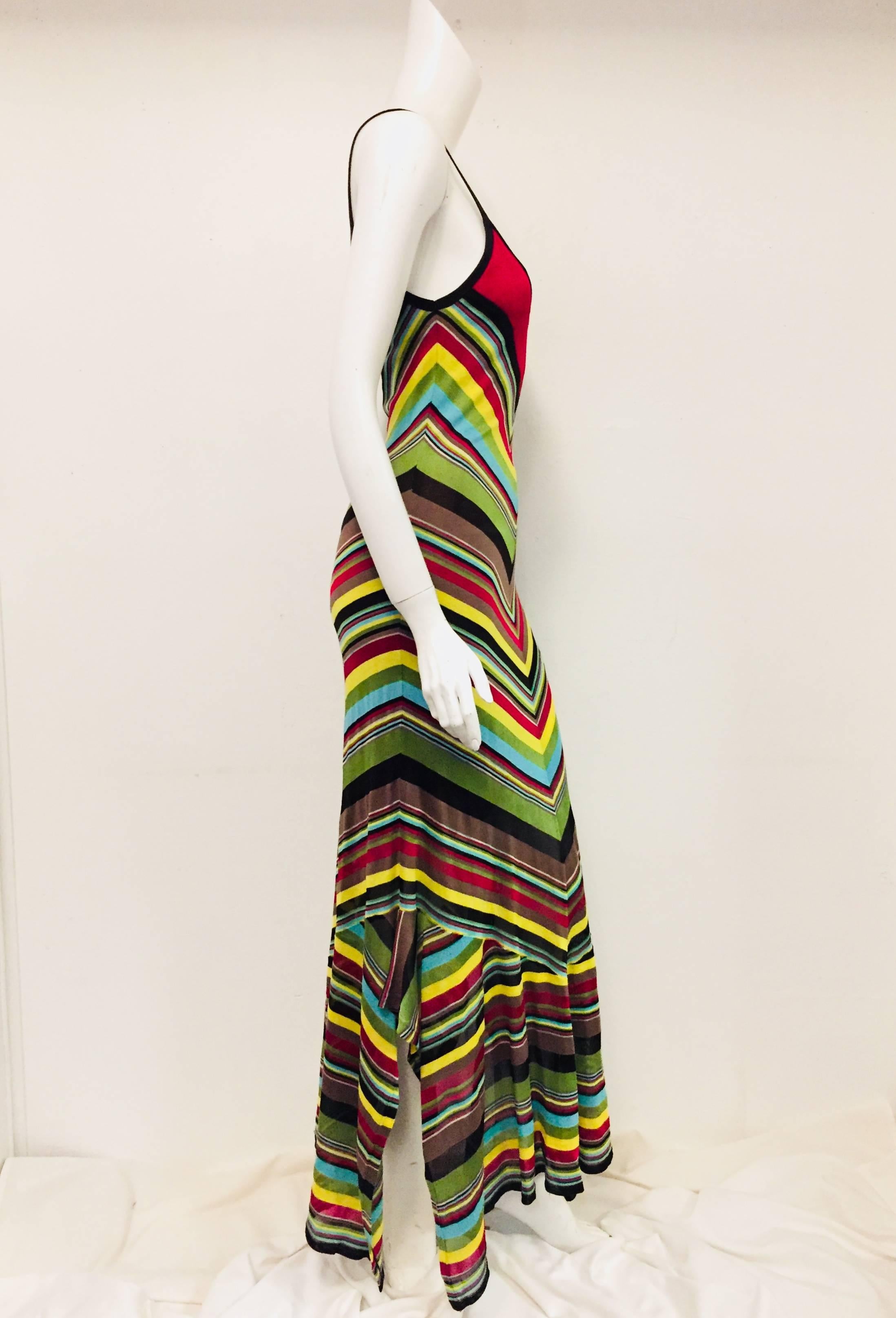 Missoni chevron pattern striped multi color long casual dress is perfect any occasion.  This knit thin strap scooped neck dress is constructed with bold bright colors and the hem is ruffled with openings on both sides.   