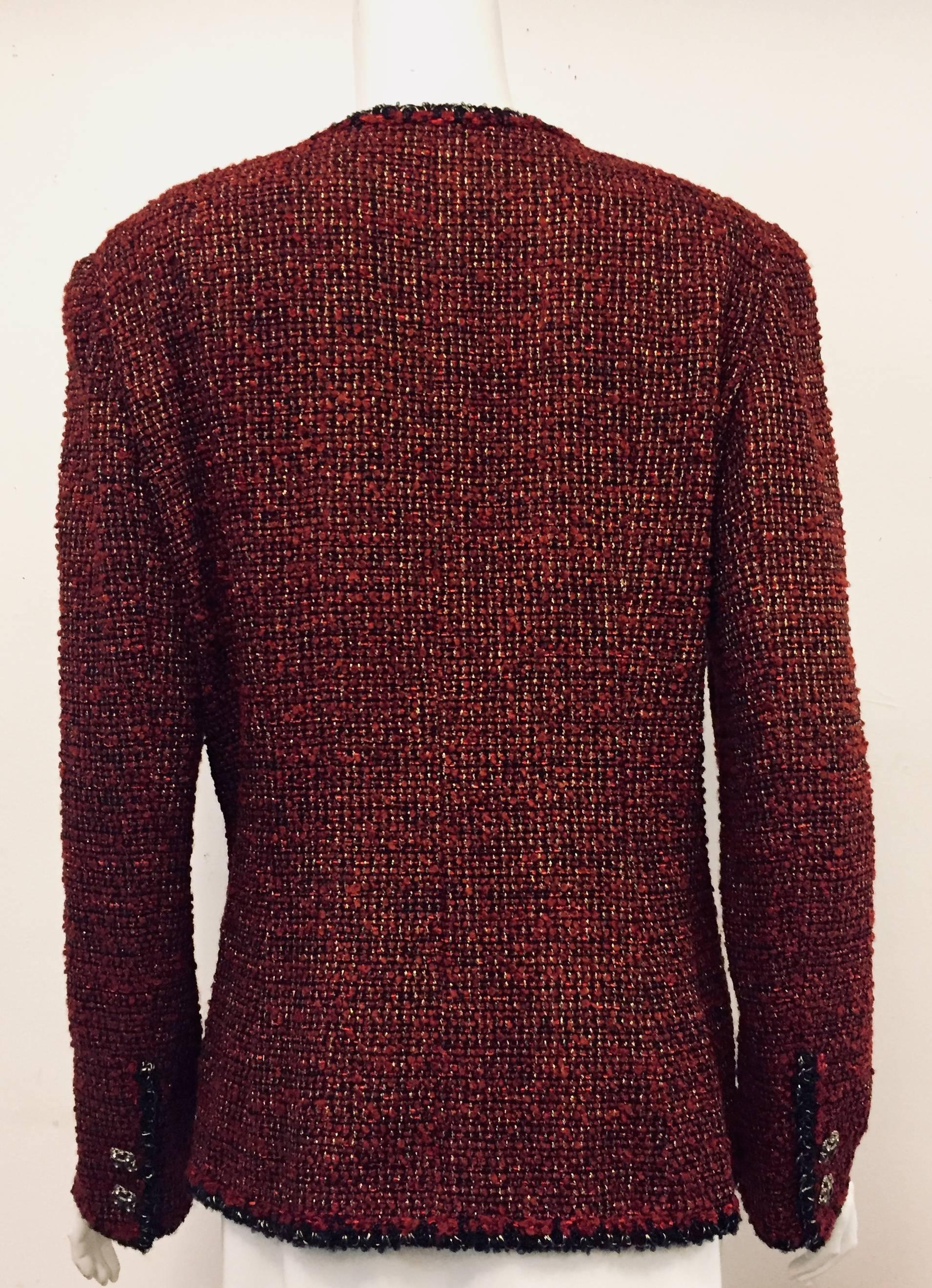 Chanel bordeaux wool blend tweed jacket is highly sought after by those loco for Coco!  This bordeaux color V neck jacket has gold tone threads throughout and black and gold tone threads trim around the neckline, front opening, hem and long sleeve