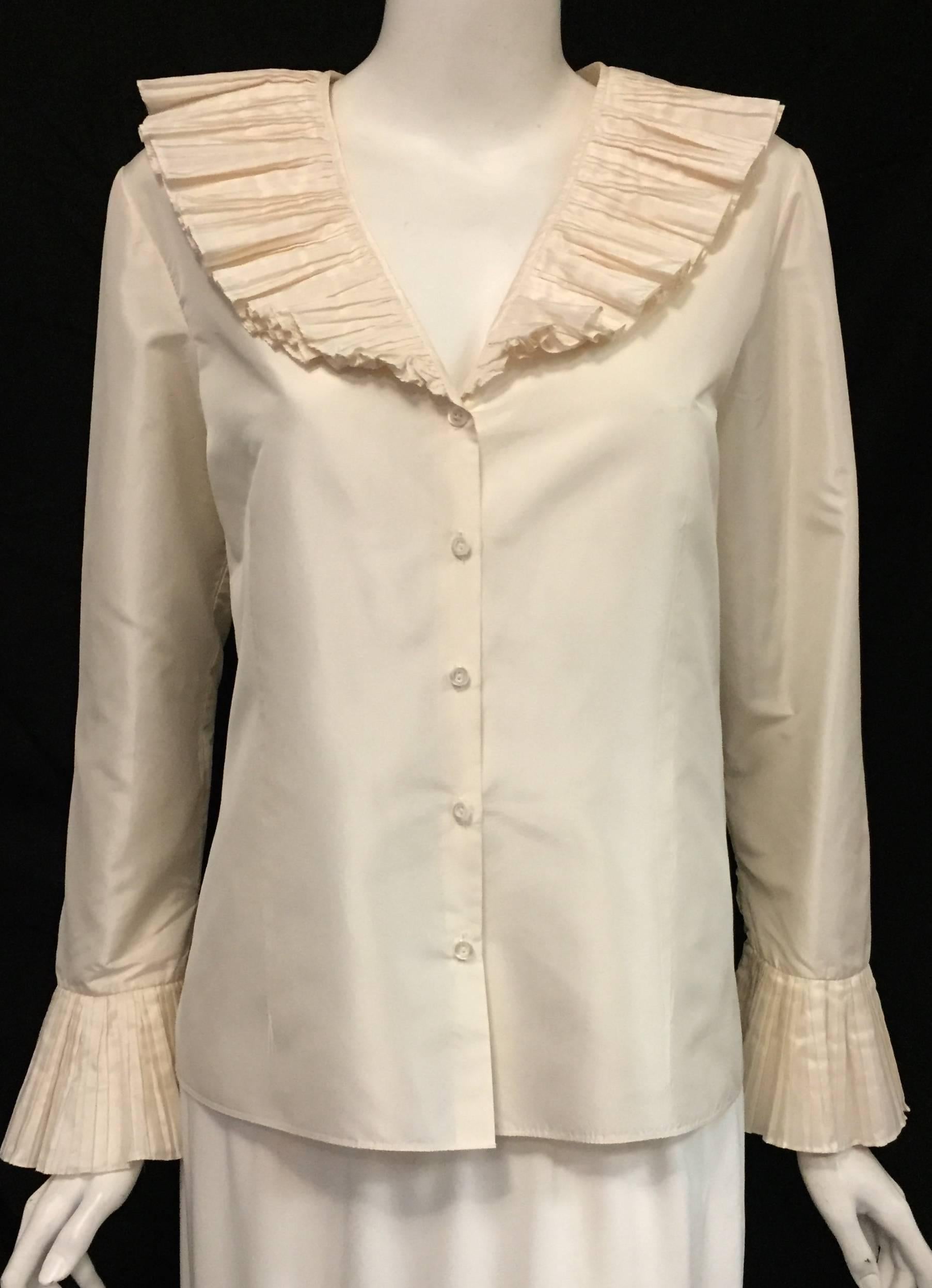 Oscar de la Renta is renown for his ultra-feminine, classic designs.  Ivory Silk Taffeta Blouse features two voluminous tiers of of fine pleats to form collar and cuffs.  V-Neckline and 5 button front closure finish the look.  The possibilities are