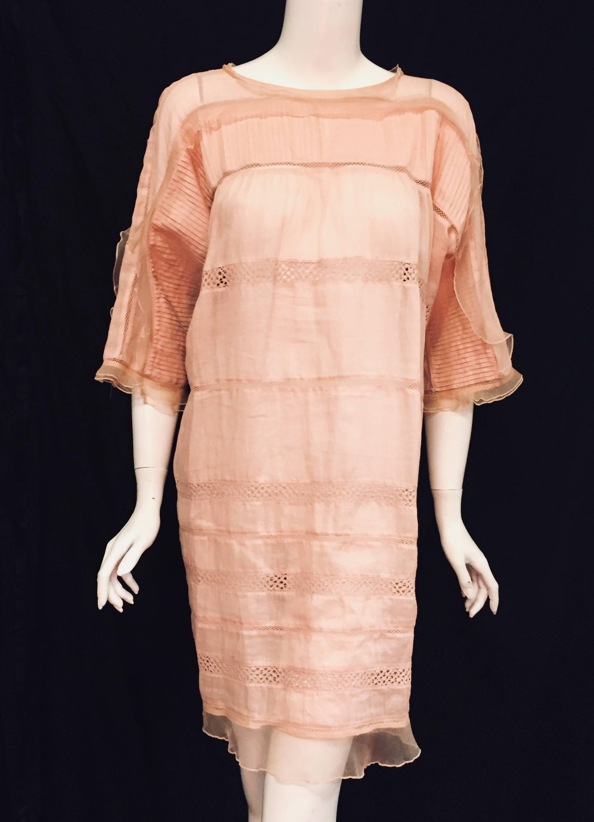 Isabel Marant Peach Ramie and Silk Dress is not only ultra-feminine, but also is light, and ethereal. This sublime and sophisticated confection is also the ultimate in Summer chic! Features include round neckline, elbow length sleeves and generous