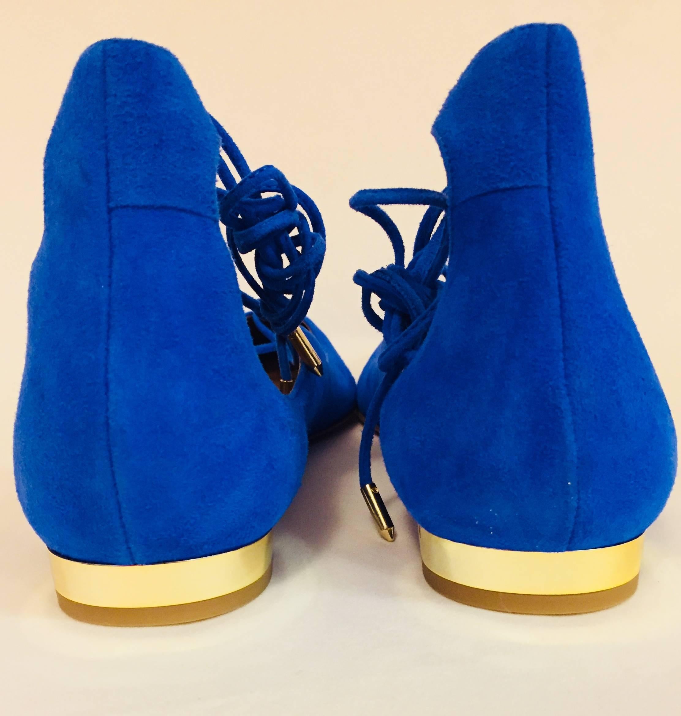 Aquazzura electric blue suede flats offer just the right amount of feminine mystique with crisscross suede laces and polished aglets.  Fabulous?   Yes!  Taupe Italian leather lining and sole.  The heels are finished with a flash of gold tone metal