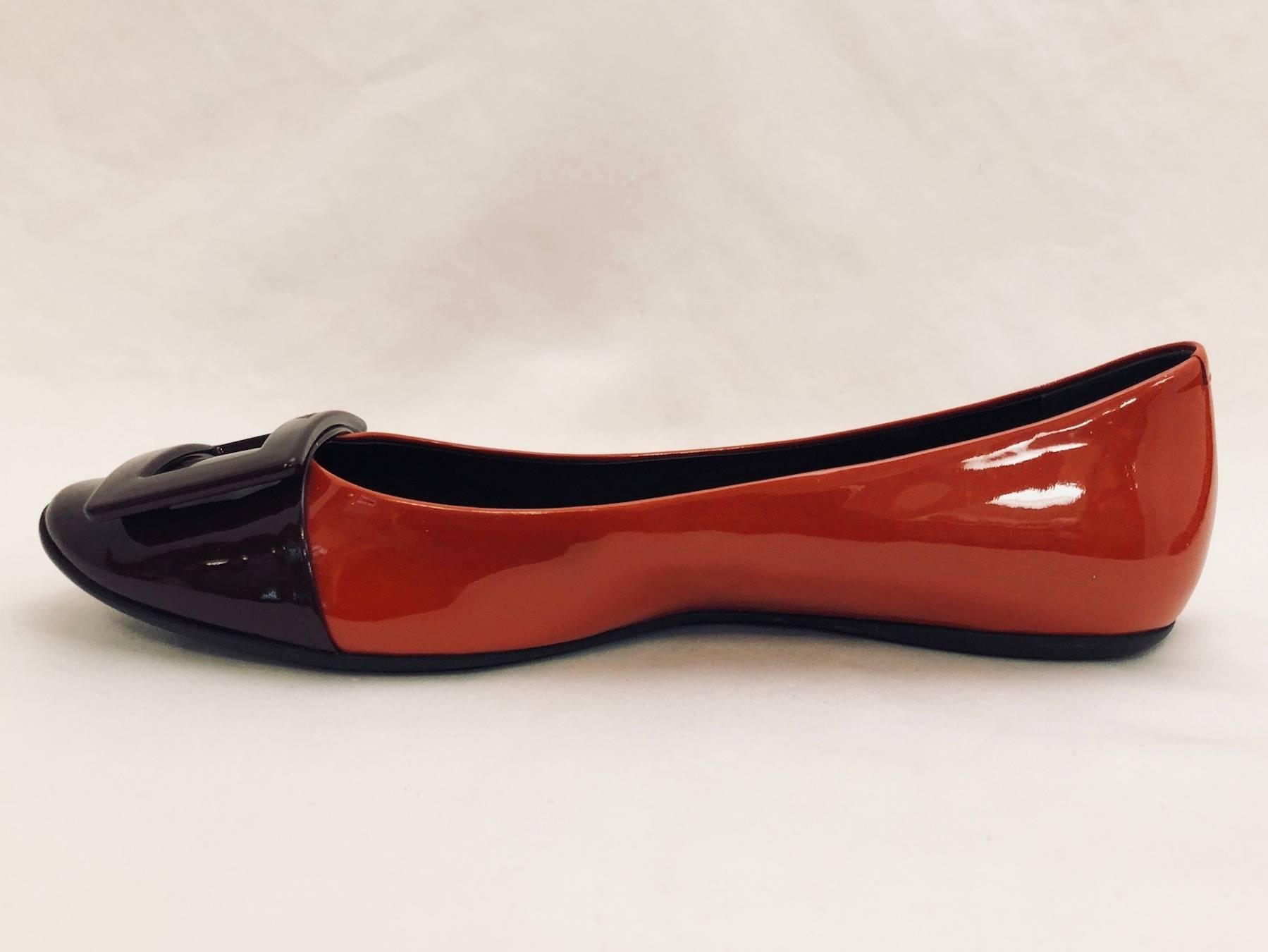 Roger Vivier is credited with creating what has become known as the Stiletto heel.  This fact makes these patent leather burnt orange and chocolate Belle de Nuit flats all the more collectible!  These have round cap toes and are lined in black