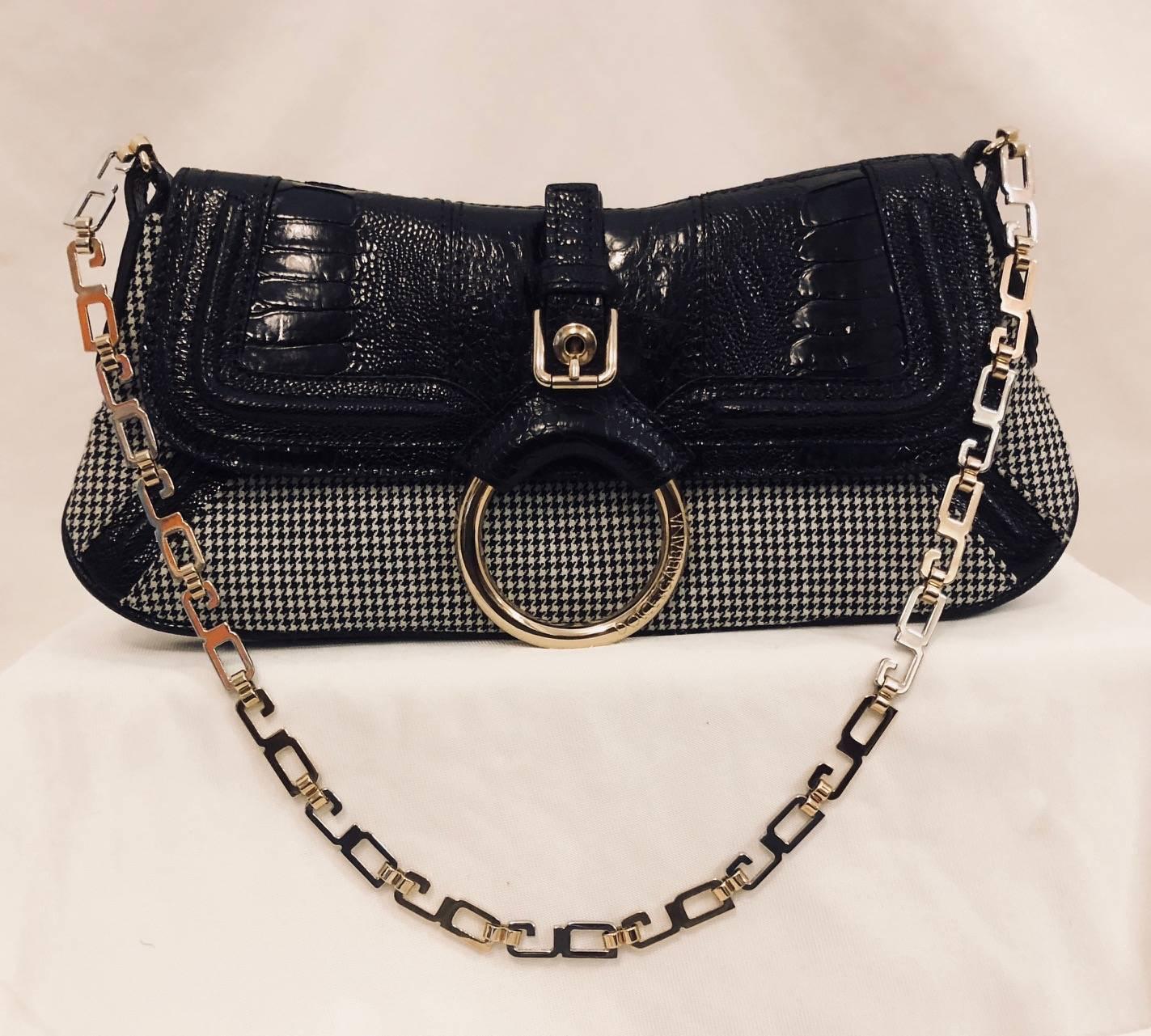 Dolce & Gabbana Black and White Houdstooth Wool Bag is fit for a lady.  Exalted Italian craftsmanship abounds with combination of fabric and exotic skin.  Structured shoulder bag features two-tone “DG” Chain Strap, gusseted body, and black lizard