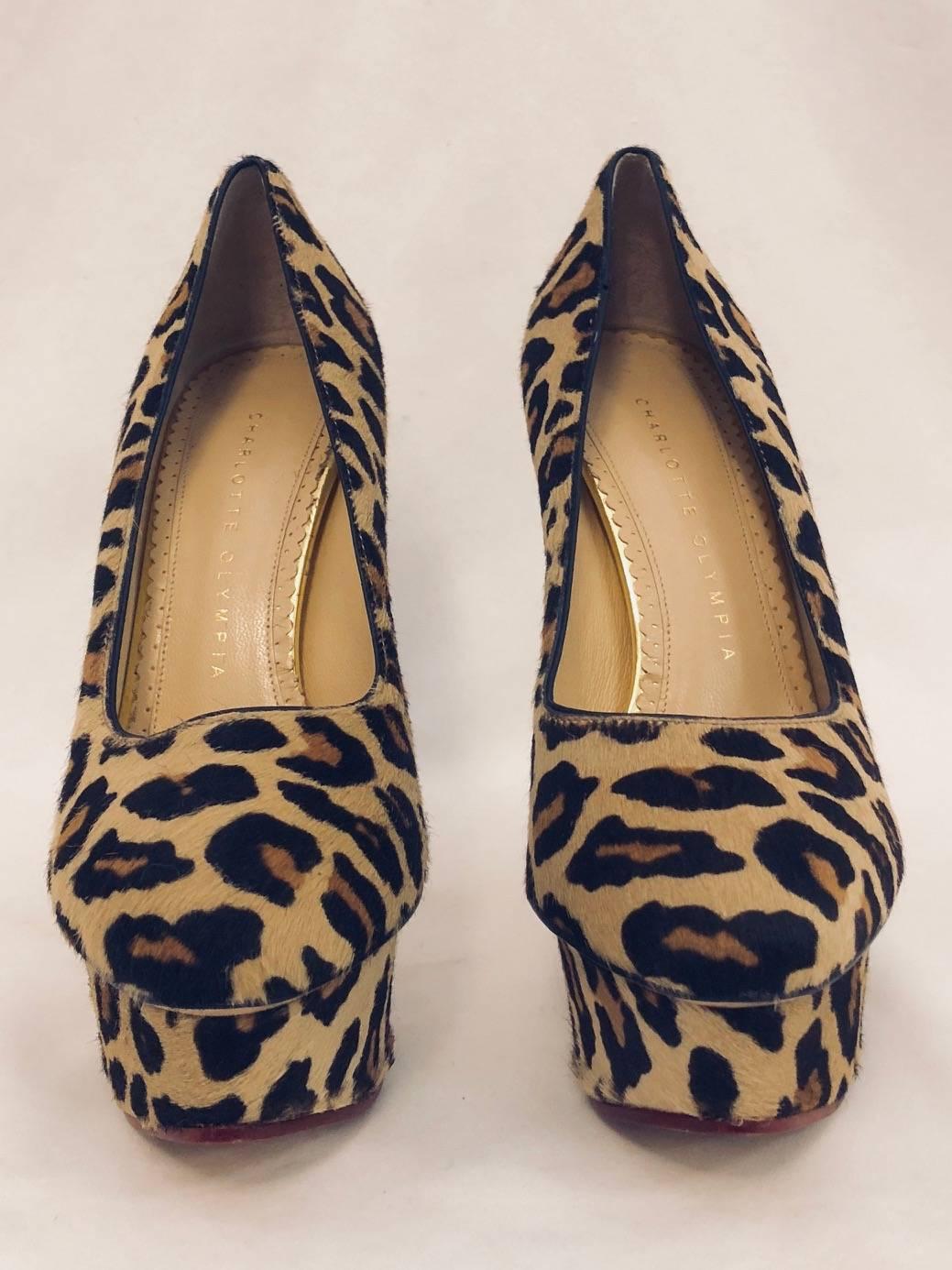 Charlotte Olympia's love of Hollywood glamour and sophistication is evident in her wildly popular ”Dolly” Pump. 
 Fit for a Siren, these unforgettable shoes feature leopard print calf hair uppers and covered platforms.  Tan leather soles, insoles