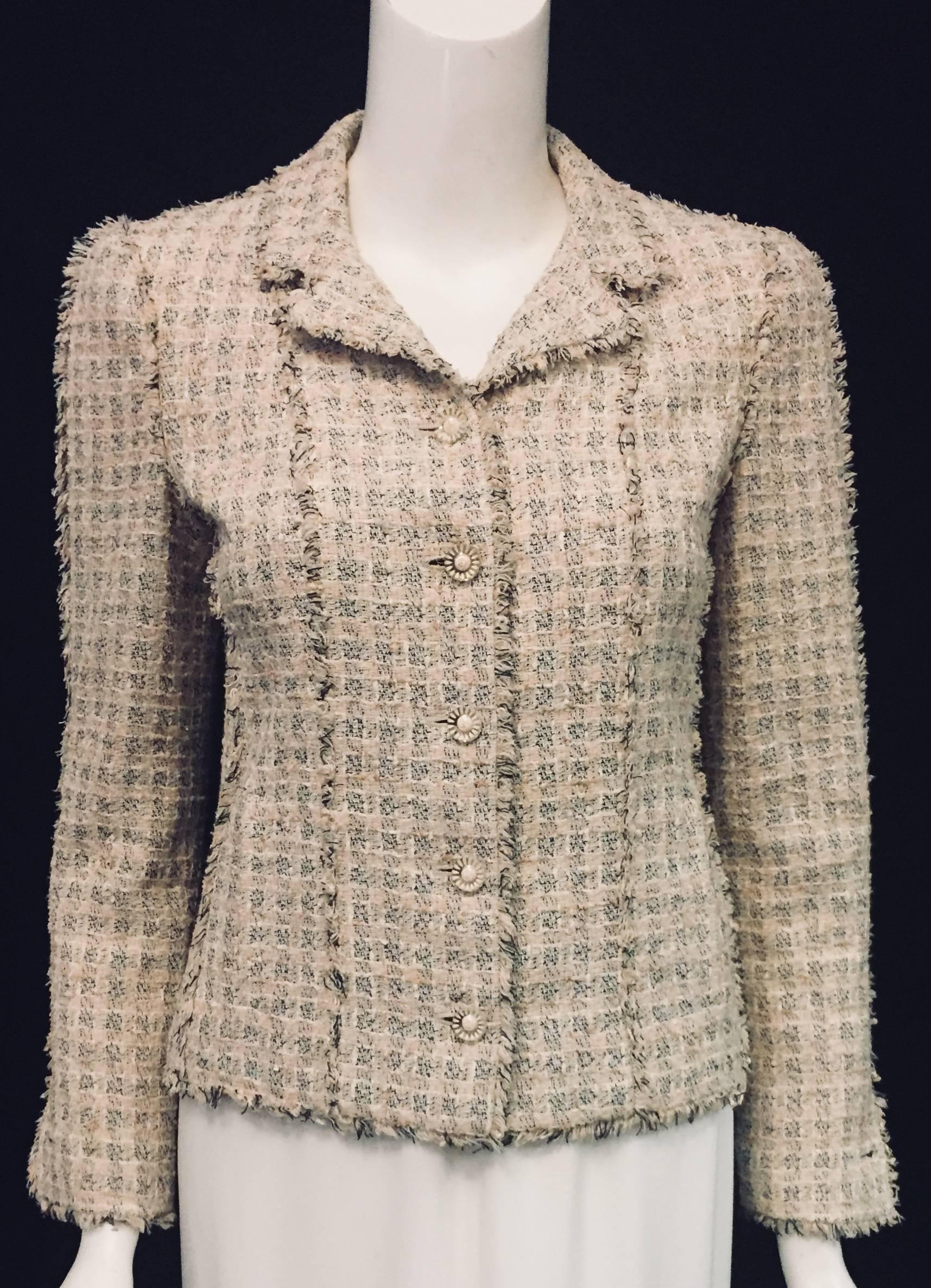 Chanel Spring Tweed Jacket is worthy of Coco herself! Features primarily cotton and silk blend tweed in shades of peach, pink, tan with just the right amount of black.  Two welt pockets are still sewn shut!  Finished with frayed trim on all seams,