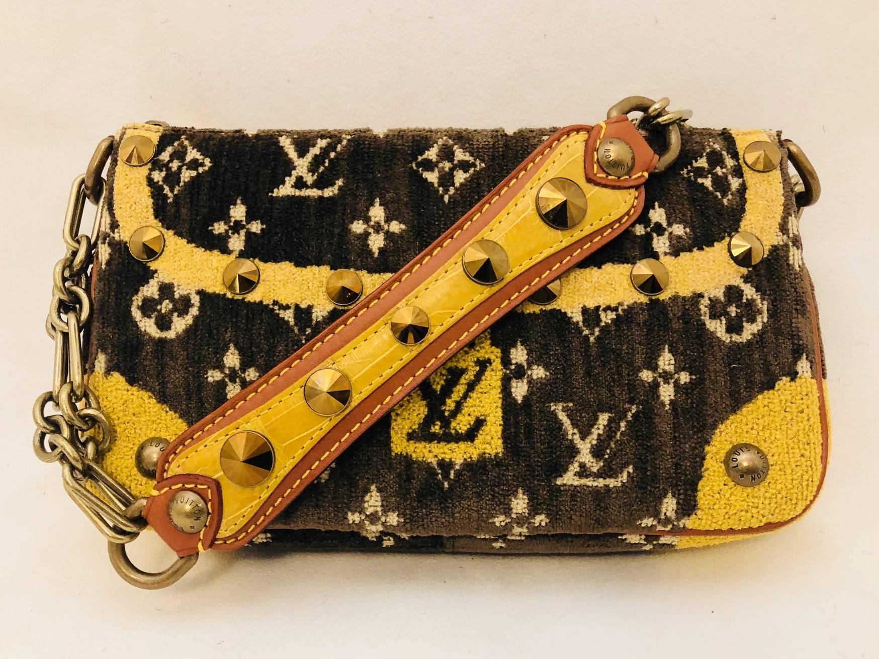 Limited Edition Louis Vuitton monogram pochette with a Trompe D'oeil design in brown and beige will have you taking a second look!  This bag has a velvet monogram exterior trimmed with dark tan leather piping on the edges and not metal studs but