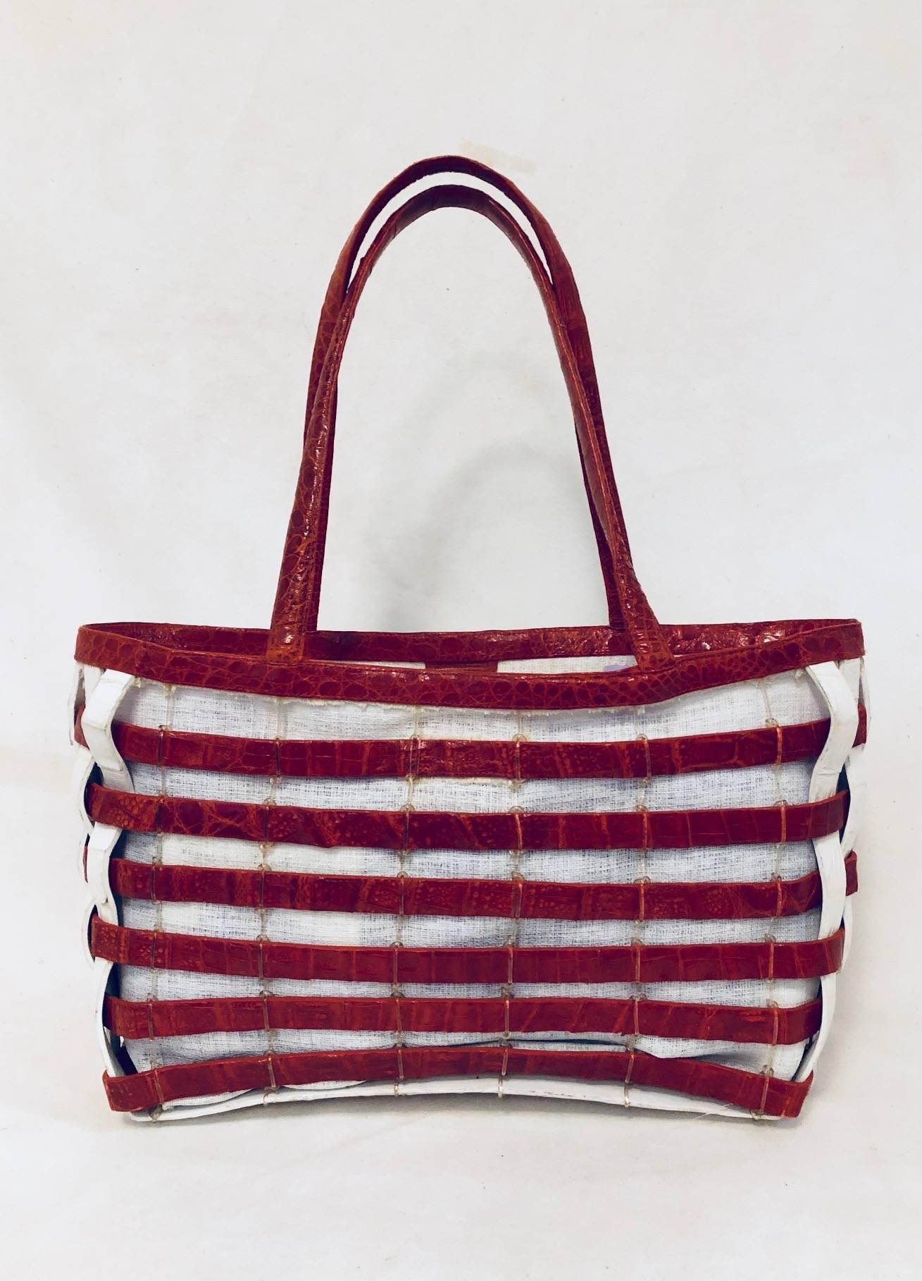 Only Nancy Gonzalez would craft an American Flag Tote using her signature Caiman Crocodile! 
 Novelty bag features dual flat handles, "Red, White and Blue" crocodile woven overlay and ivory canvas interior.  Magnetic caiman crocodile