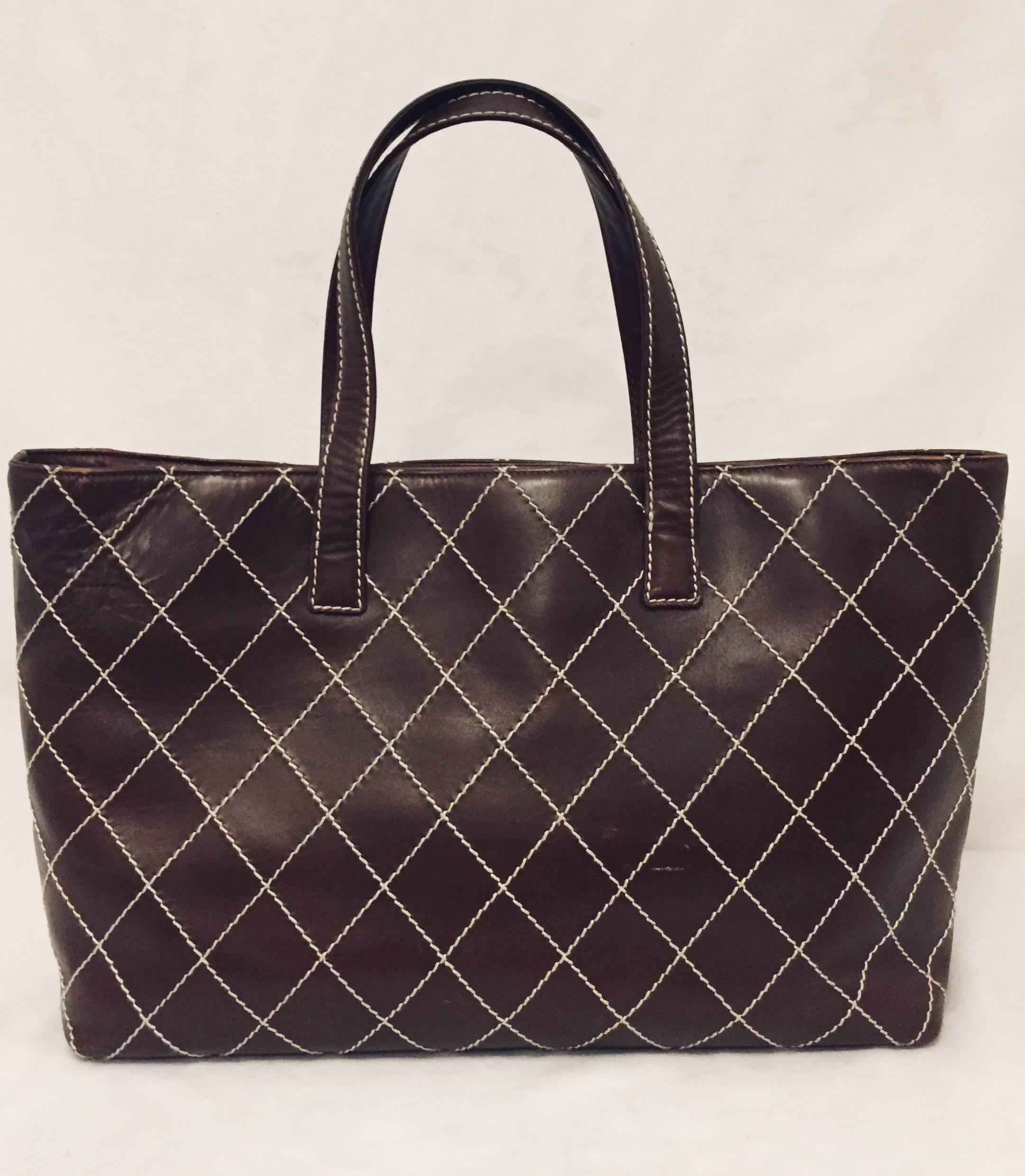 This Chanel brown lambskin leather in quilted diamond pattern and contrasting beige stitch detail is a perfect bag for every day,  going shopping or  for a quick overnight stay for your necessities.  The inside has one large pocket with a side slit