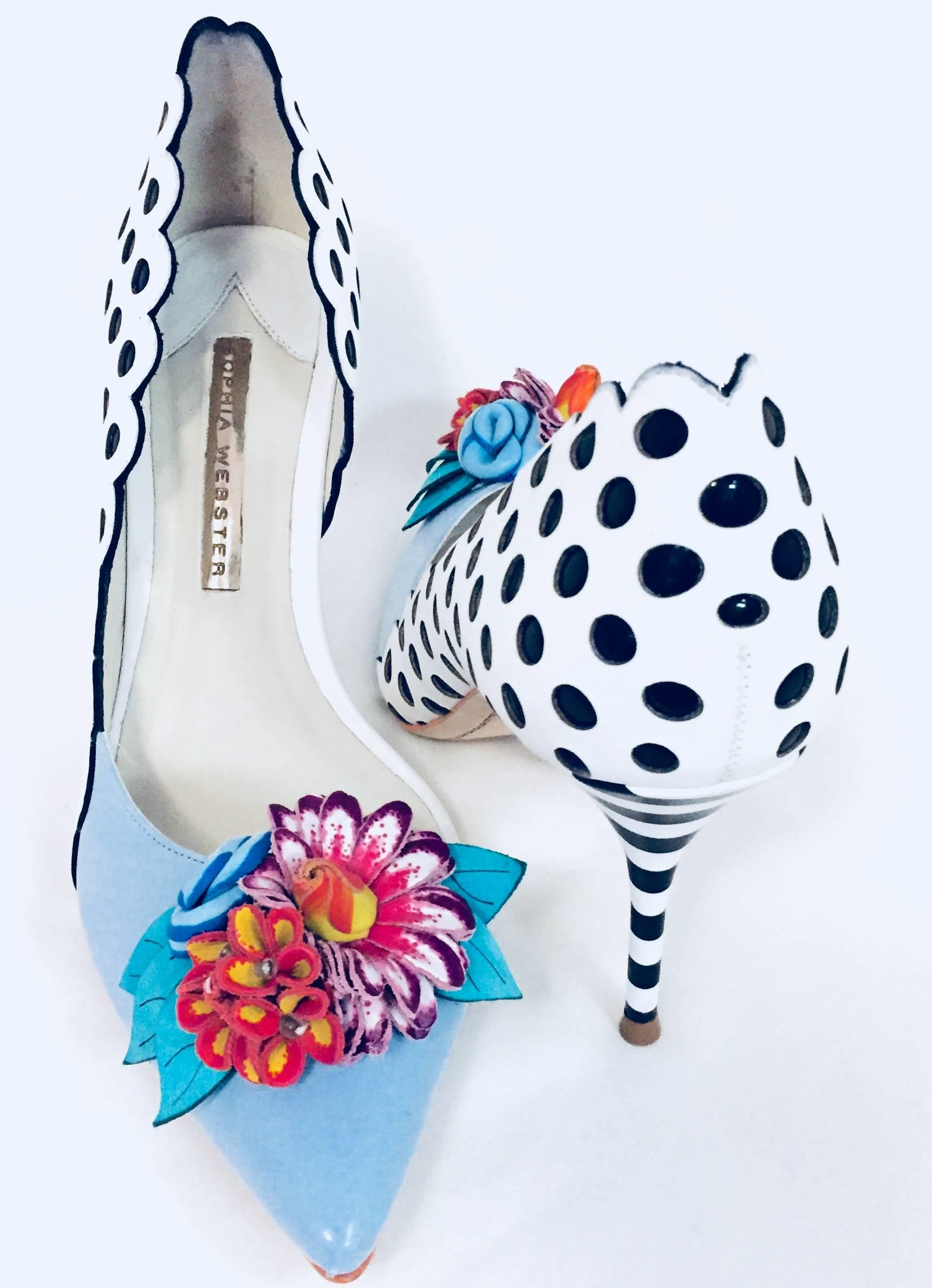 Sophia Webster's black & white polka dots with scalloped edges Dorsay pumps are fun and creative.  The Lilico flower embellished on the pale blue leather pointed toe pumps epitomizes the London based designer's playful aesthetic.  Crafted from white