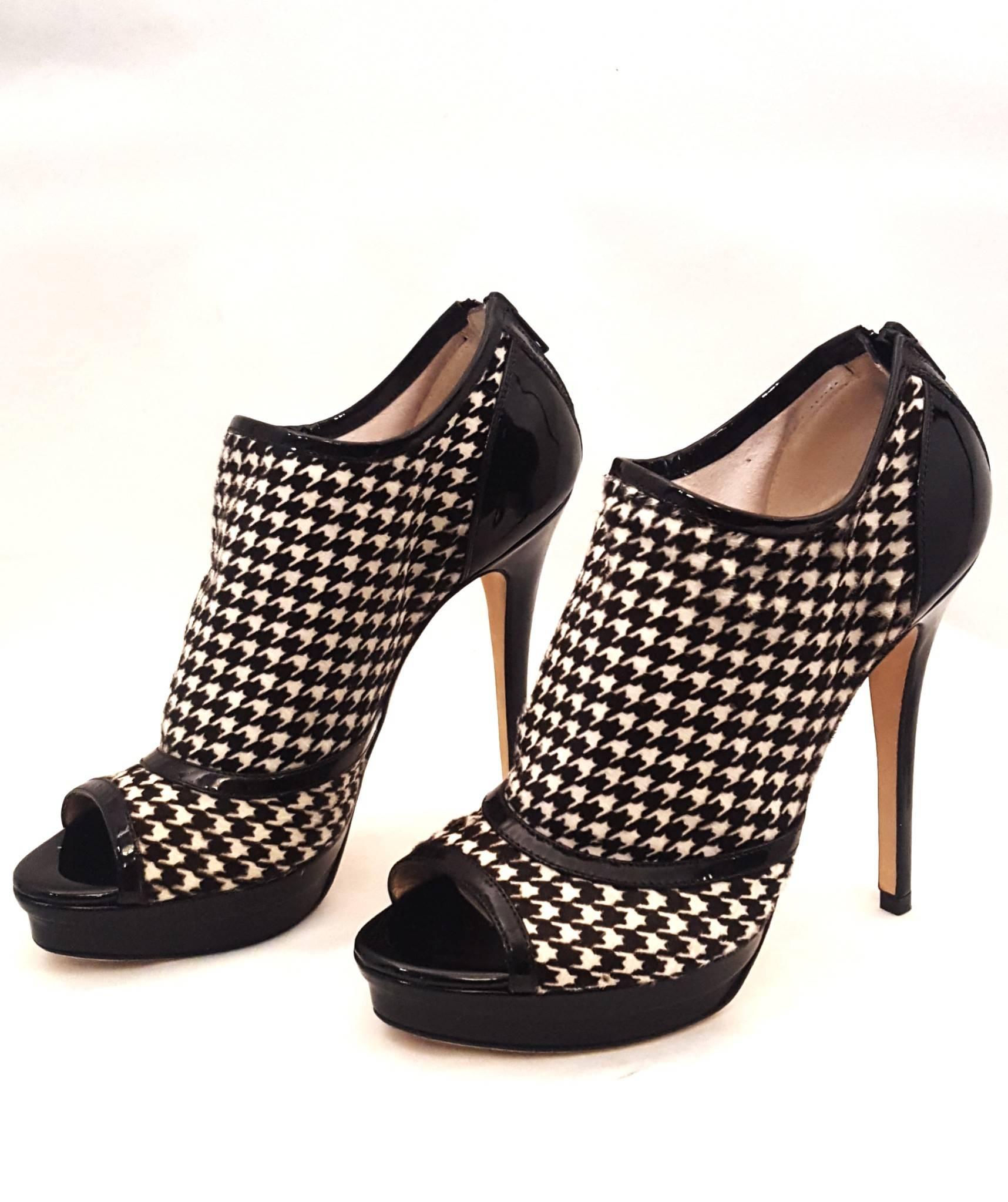 Jerome C. Rousseau Elli black patent with black and white Houndstooth print fabric is a favorite of ours!  These boots are fully lined in ivory leather including the insole and have a zipper at back of heel for closure.  The houndstooth print boots