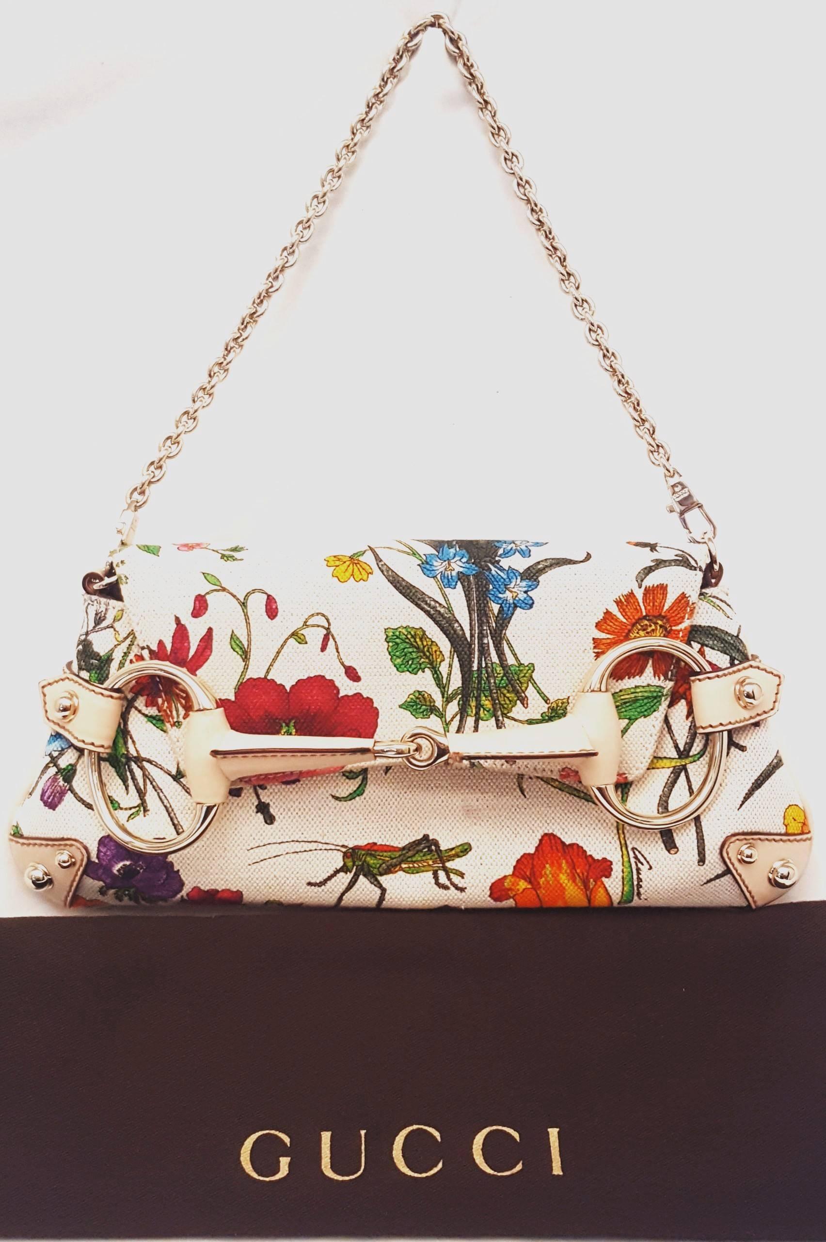 Gucci Flora printed canvas bag with horse-bit decoration on flap is a luxurious and elegant piece.  The outside leather is a beautiful pinkish beige color and the inside is lined in beige leather on the flap.  The interior is of beige canvas on the