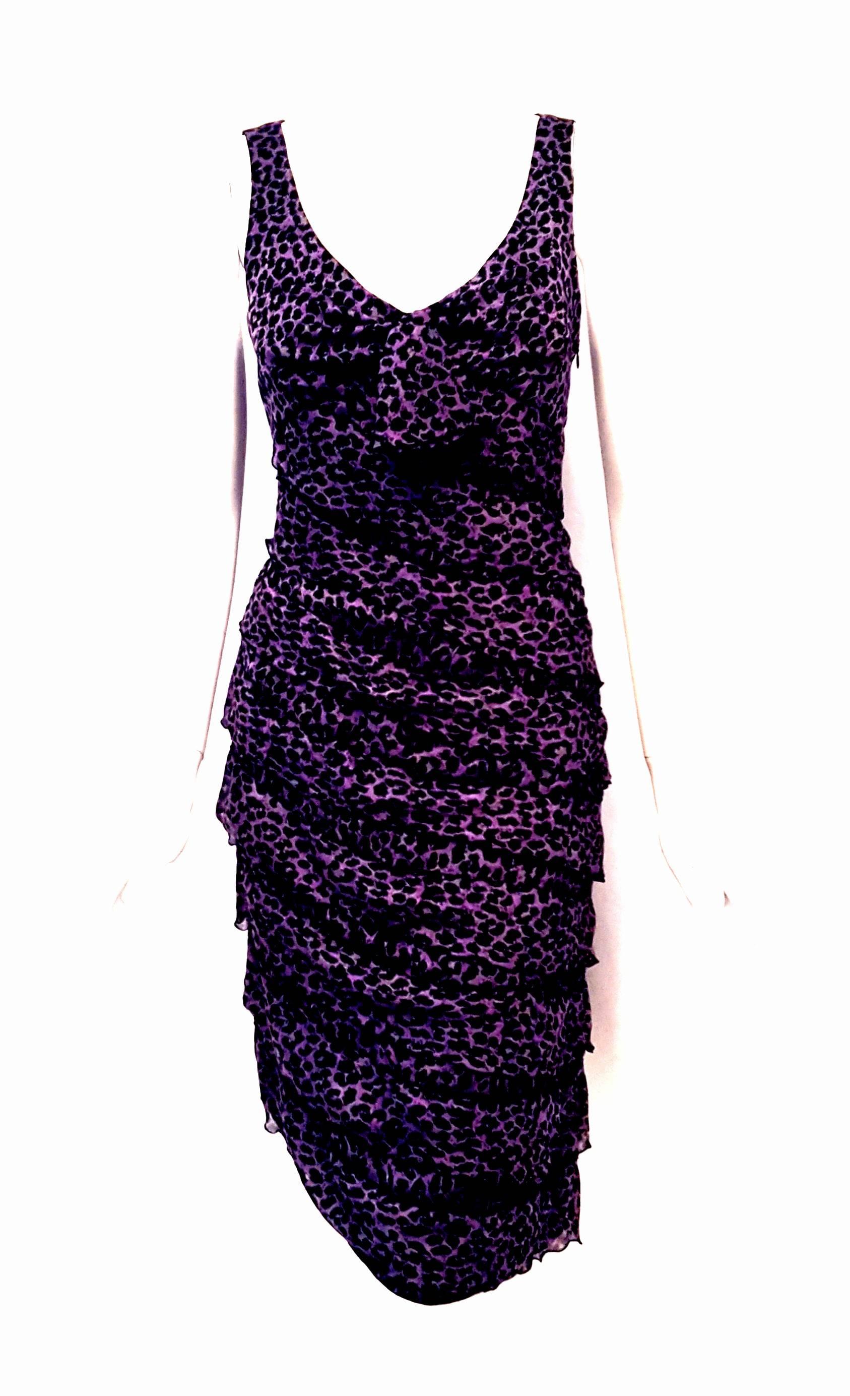 This Giorgio Armani silk purple and black animal print dress is absolutely the perfect dress for summer.  This sleeveless silk dress with its tiered ruffles is lightweight and flowy.   Sexy and beautifully tailored, it contains a side zipper for