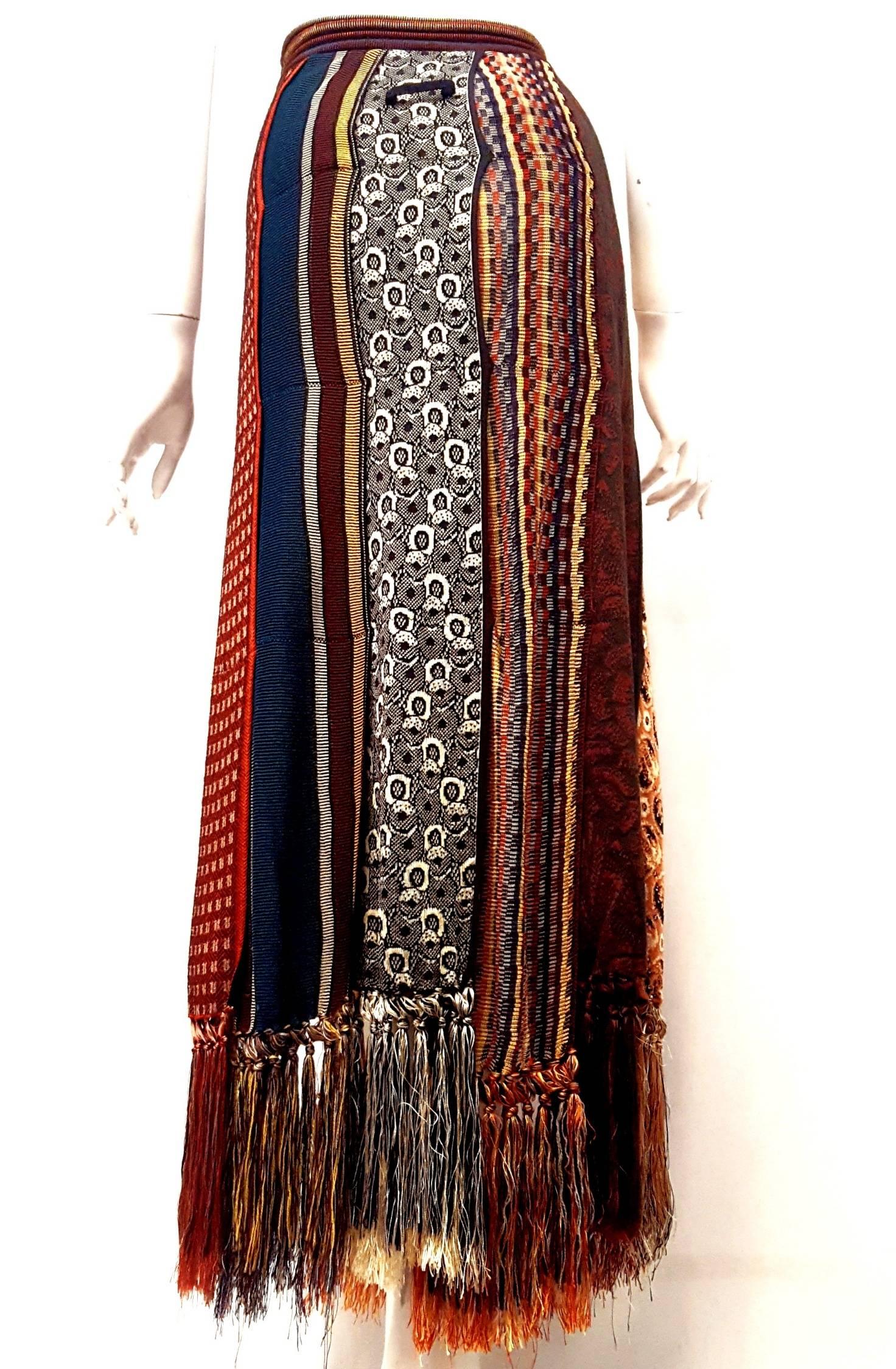 Fun and flirty multicolour Jean Paul Gaultier skirt with striking individual tiered scarf panels throughout, matching fringe at bottom hem, and elasticized waistband is a perfect summer piece!  It is made in Italy and done in a FABULOUS, multi-color