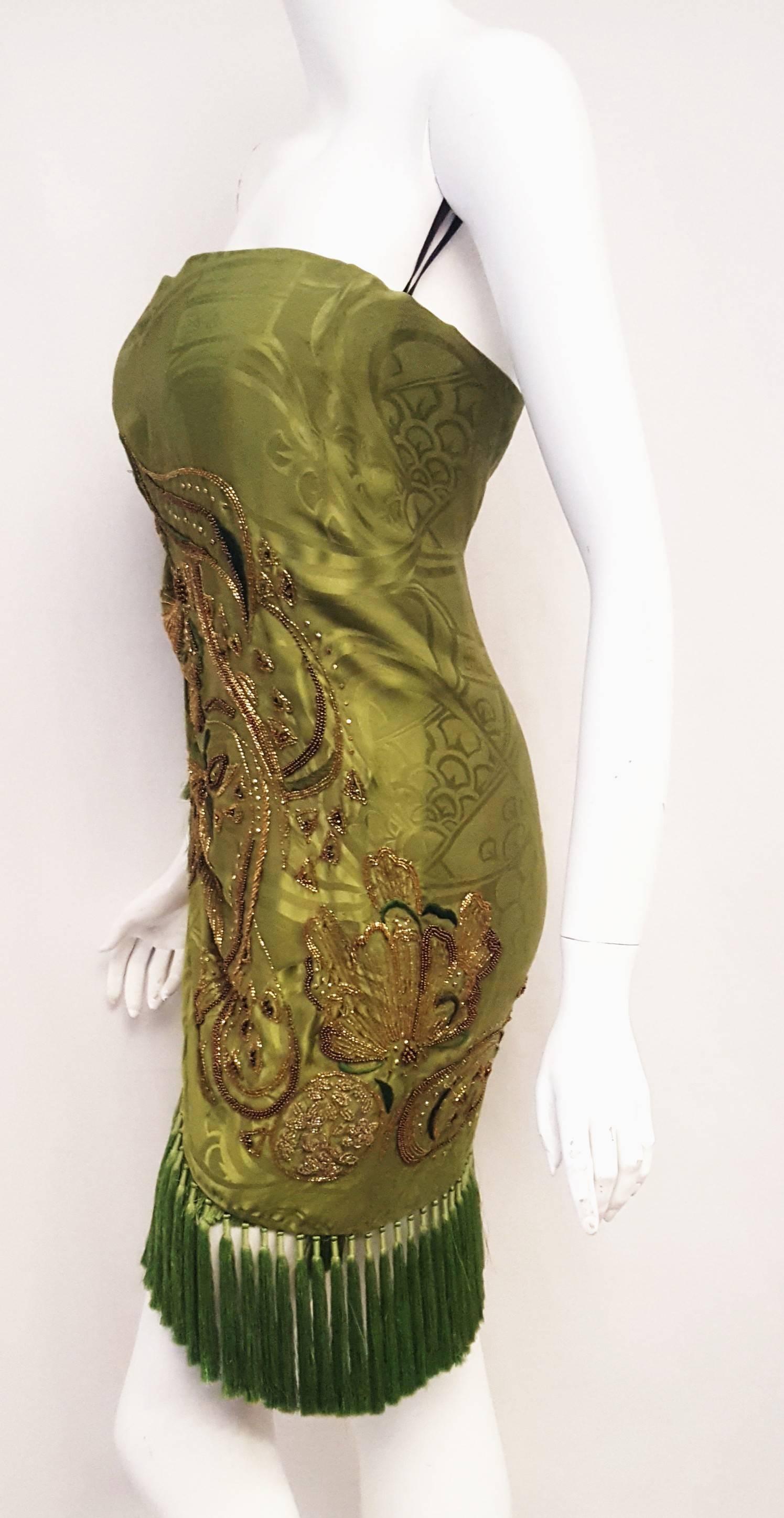 Steal the limelight in Emilio Pucci's strapless green kimono silk mini dress with beautiful beading. Balance this style with bohemian fringing on the silk strapless mini dress!  Emilio Pucci dress has a wrap-over front, gold and bronze sequin and