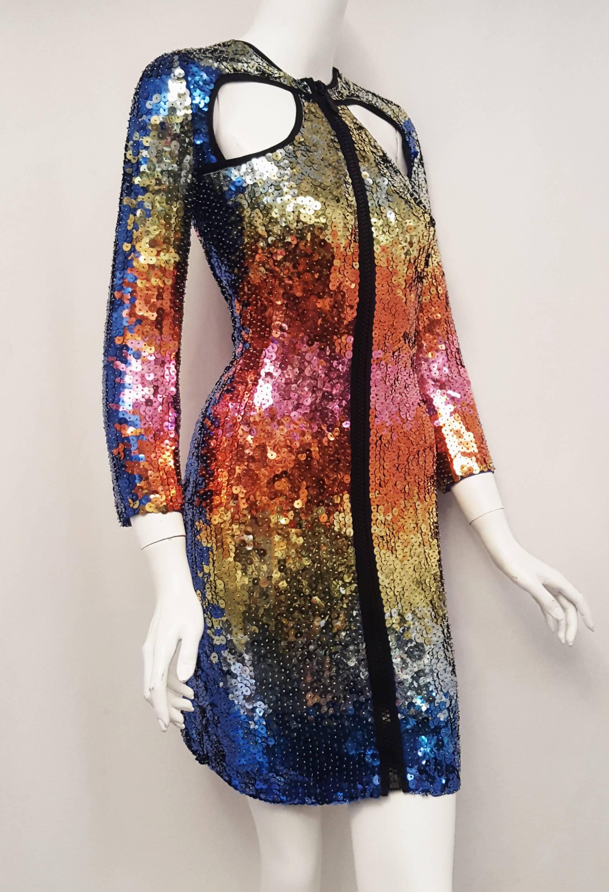 Emilio Pucci kaleidoscopic sequined dress in a rainbow pattern across the front and back of dress.  This round collar dress has two cut outs in the front just below the shoulder and two in the back from below the shoulder to the waist, the cut outs