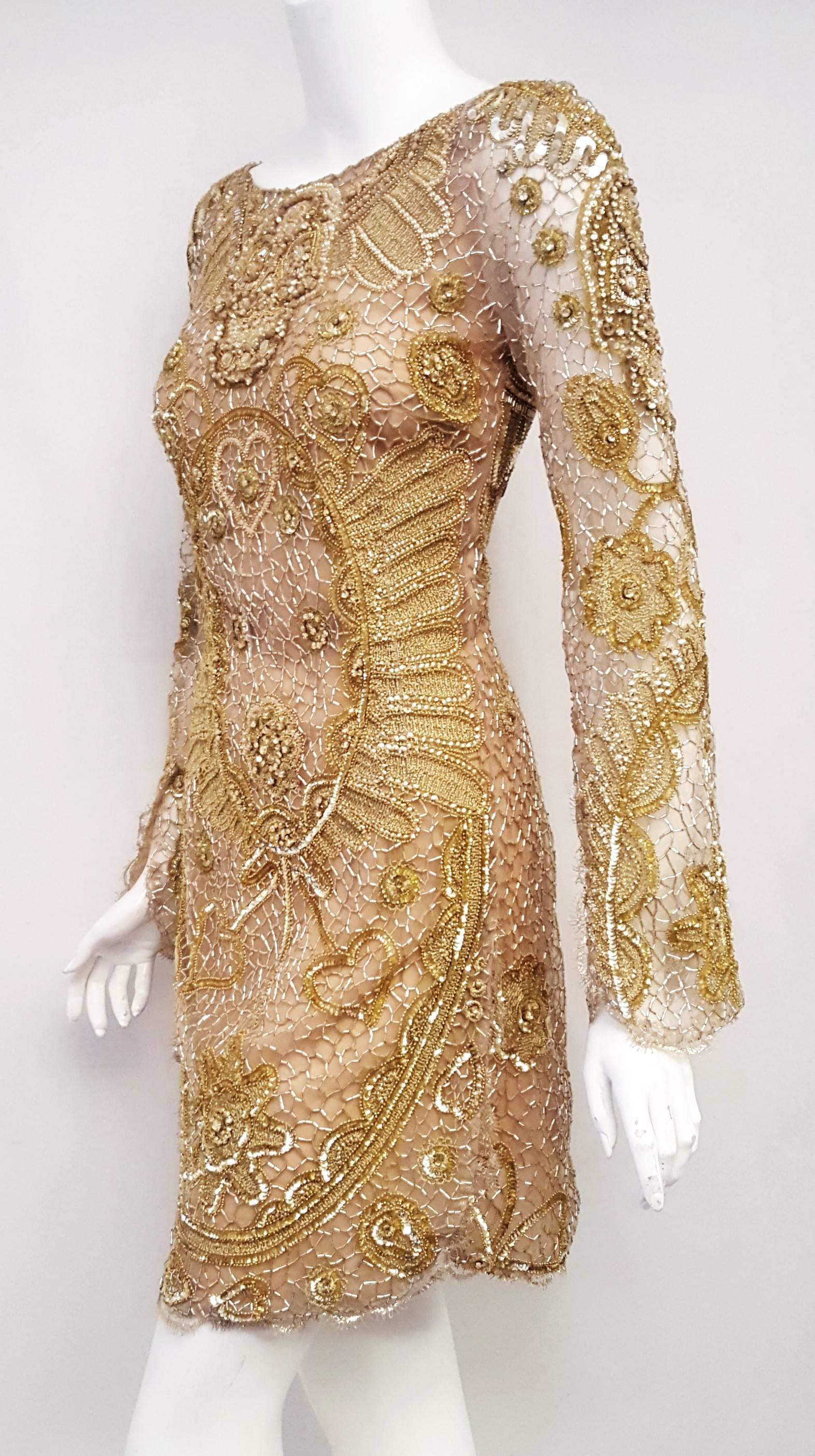 Emilio Pucci gold tone detailed beaded runway dress is a showstopper! This dress is from the 2012 Spring collection and one of Peter Dundas best design of the year!  Starting at the round neckline and on the chest is a brilliant skull is designed