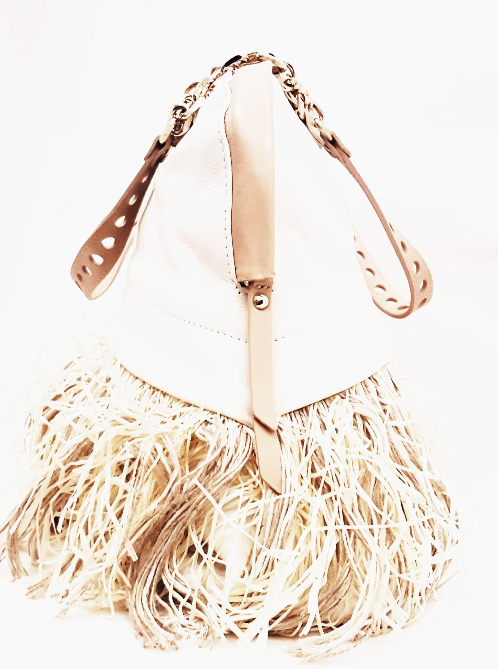 Christian Louboutin ivory leather with multi materials fringe all around the bag is exceptional and so practical for this season.  The fringe is composed of raffia, silk strings and hemp strings creating a total summer feeling, casual yet elegant. 